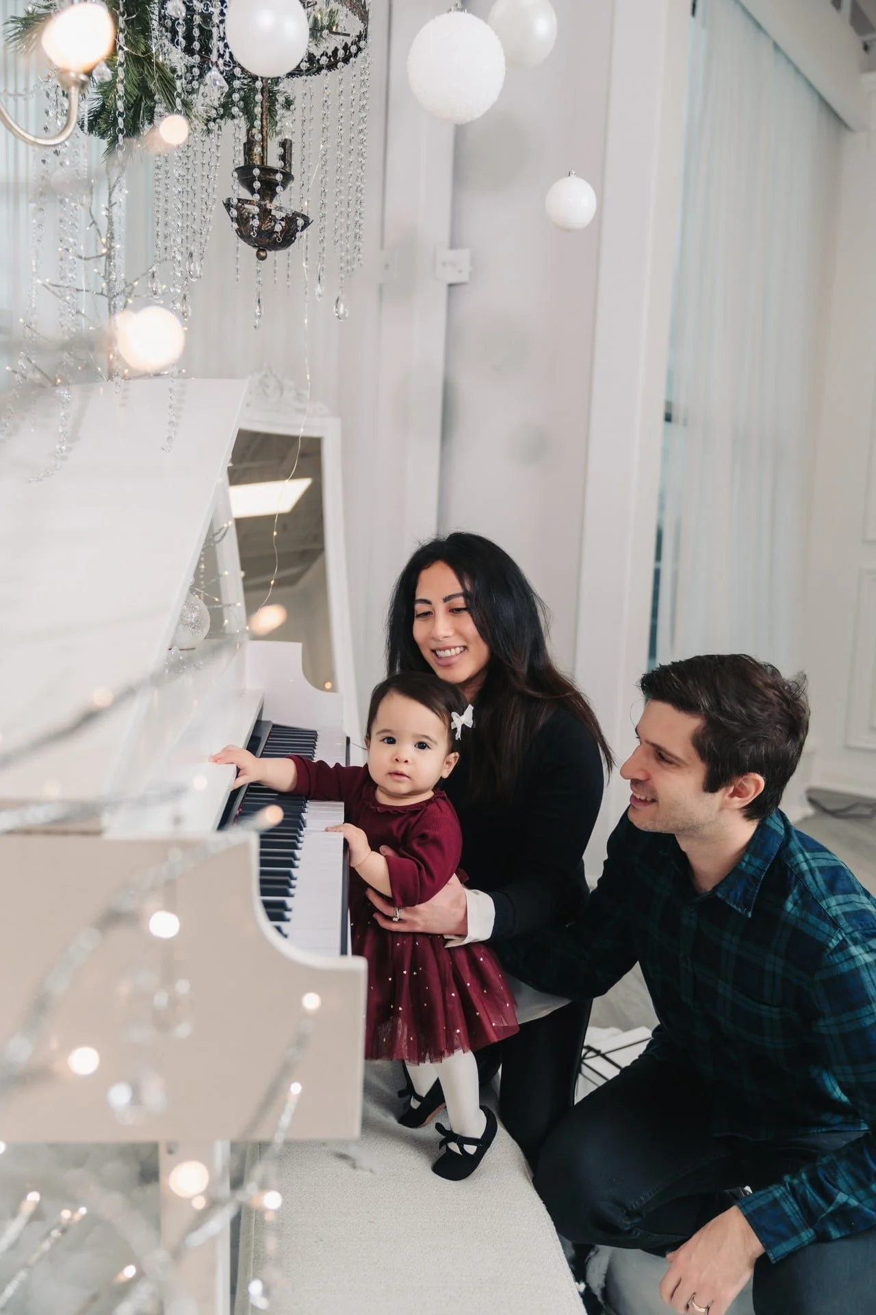 Dad and daughter sharing a piano moment at a Toronto Christmas photoshoot