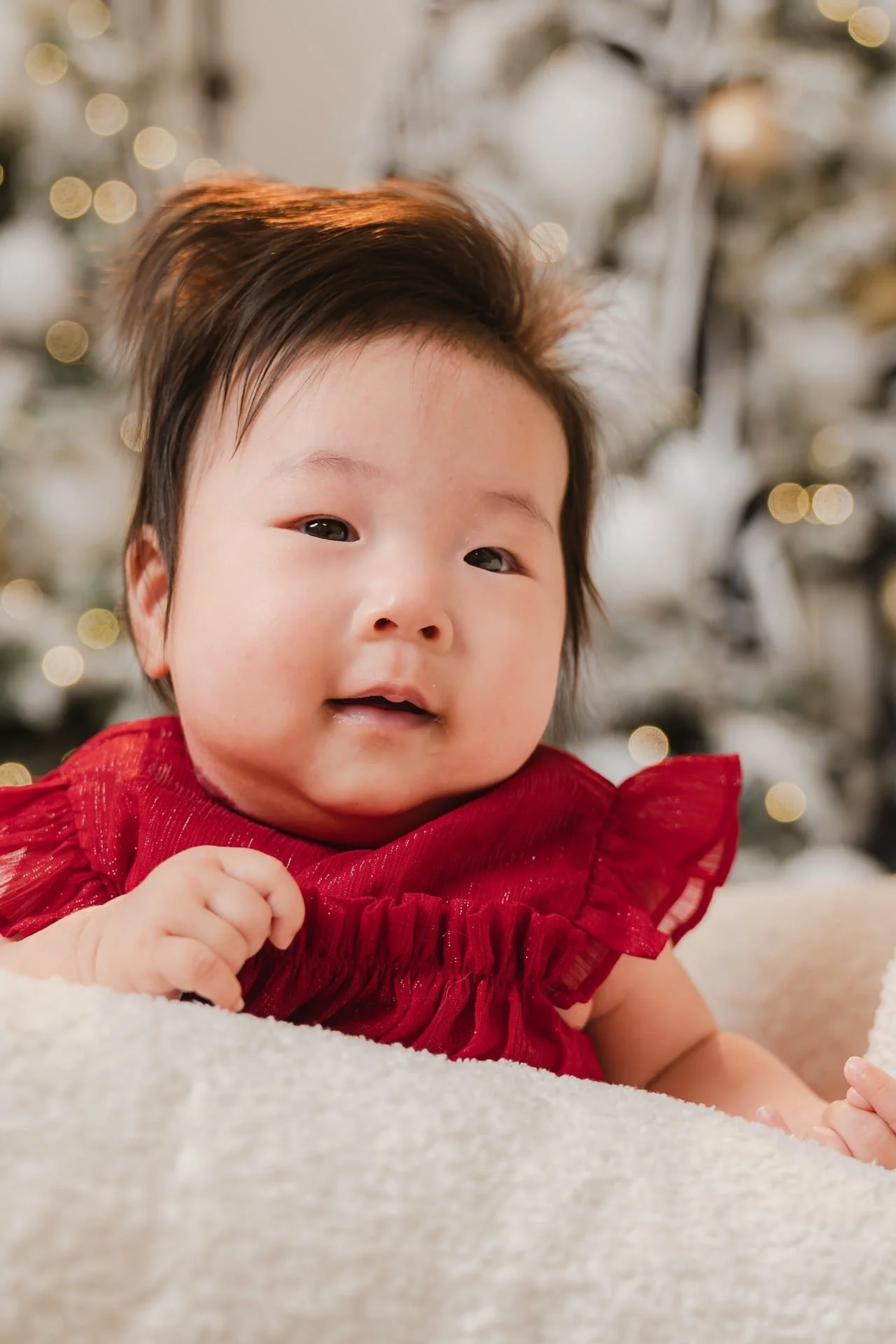 Baby girl in a red dress at her first Christmas mini session, Toronto