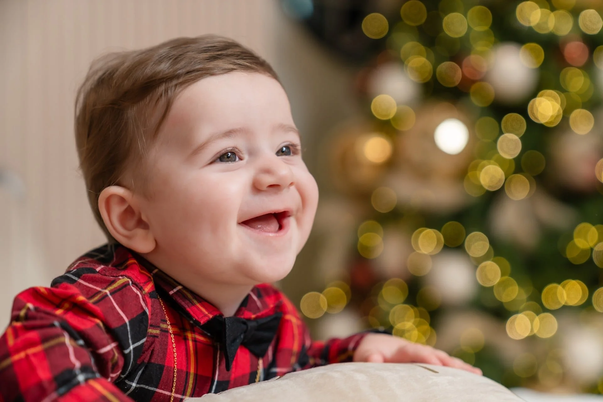 Baby boy in plaid and bow tie at a Toronto first Christmas photoshoot