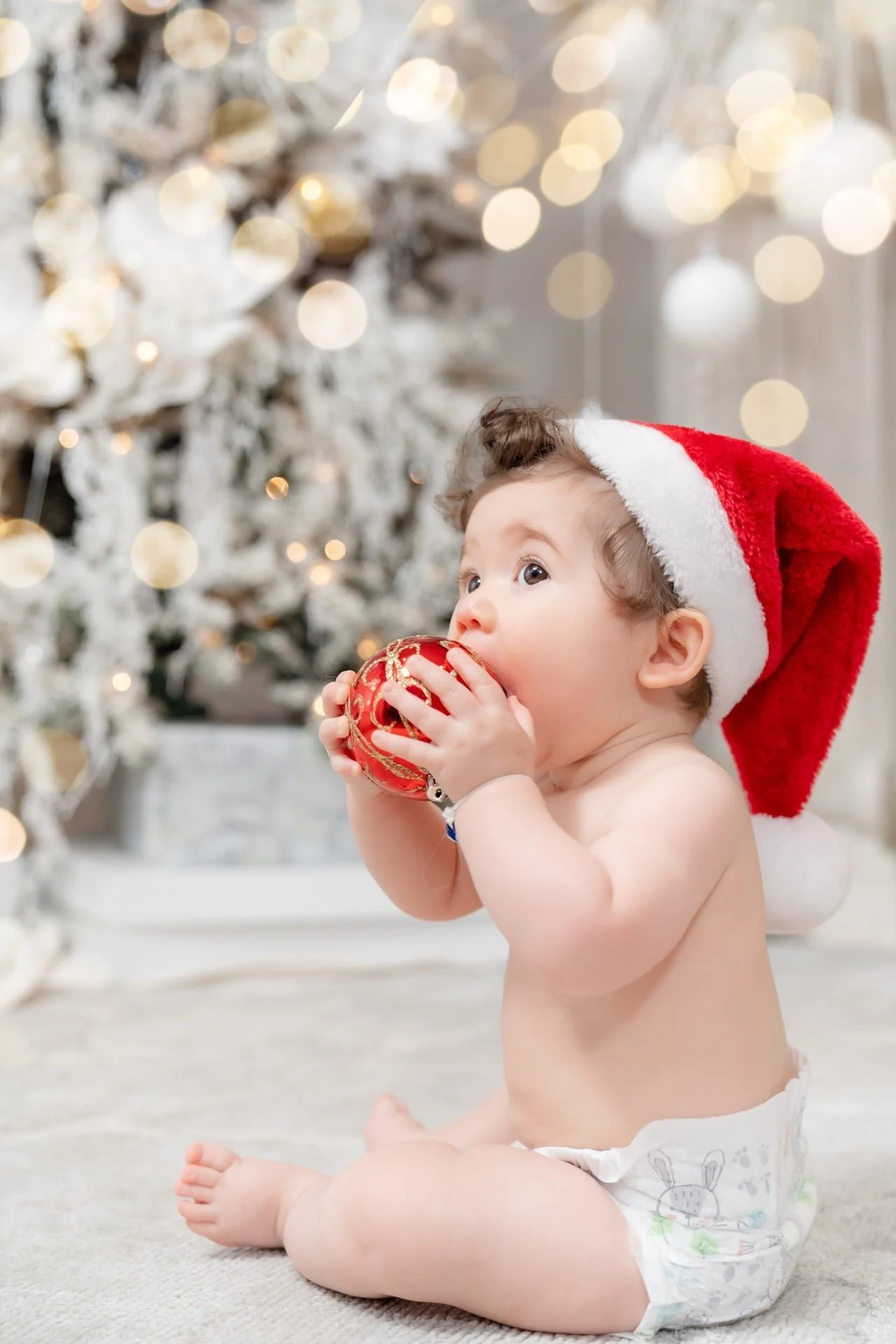 Baby in a Santa hat at a Toronto first Christmas photoshoot
