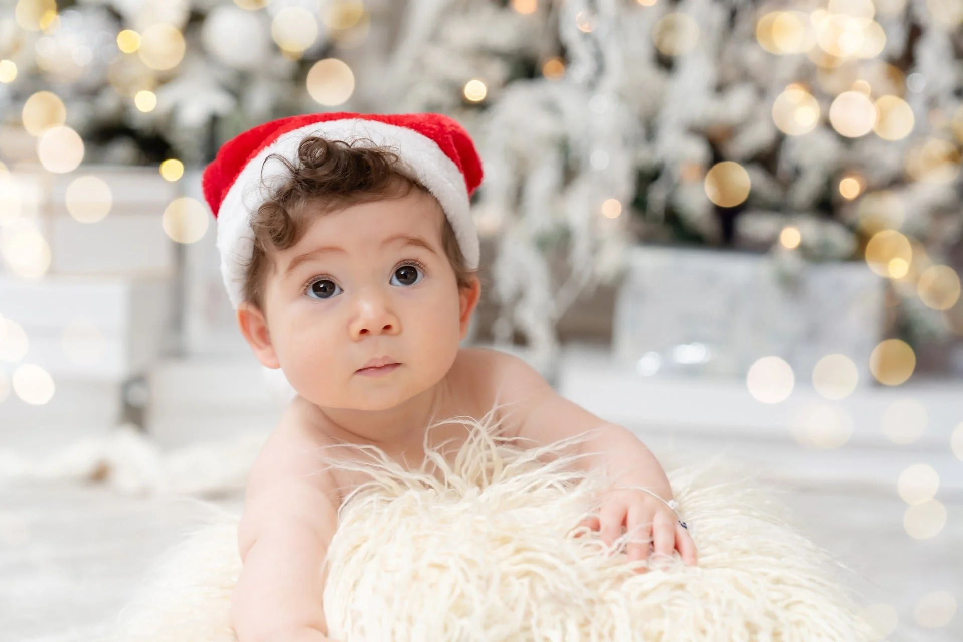 Baby in a Santa hat at a first Christmas mini session in Toronto