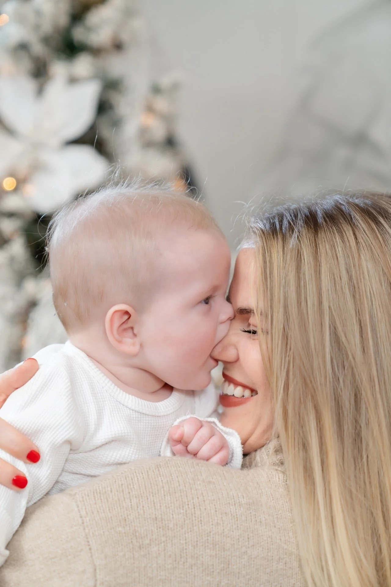Mother kissing her baby at a first Christmas mini session in Toronto