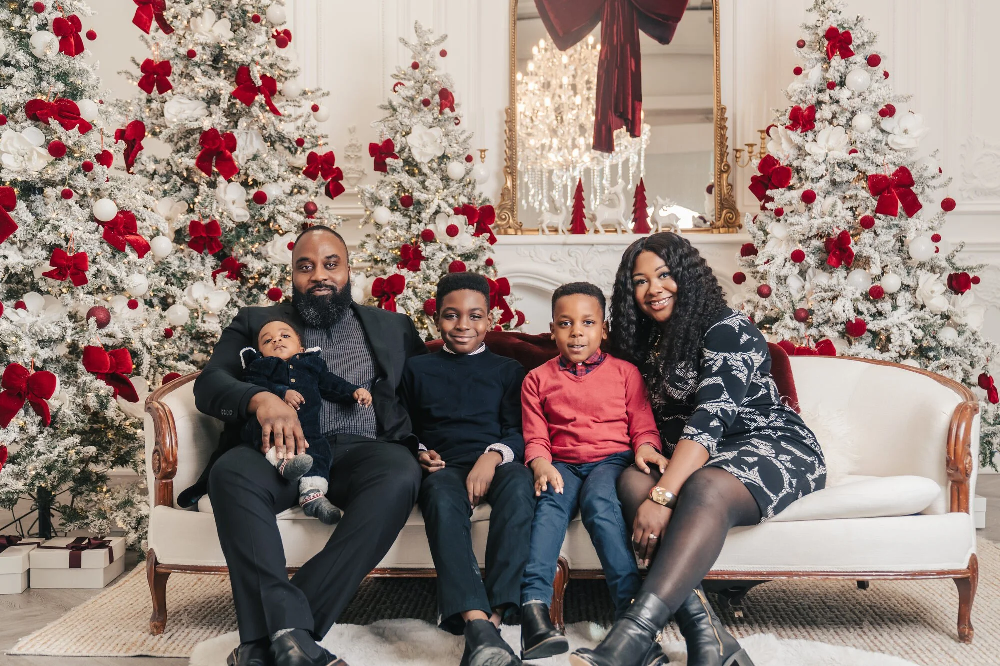 Family together on the sofa at a styled Christmas mini session studio in Toronto