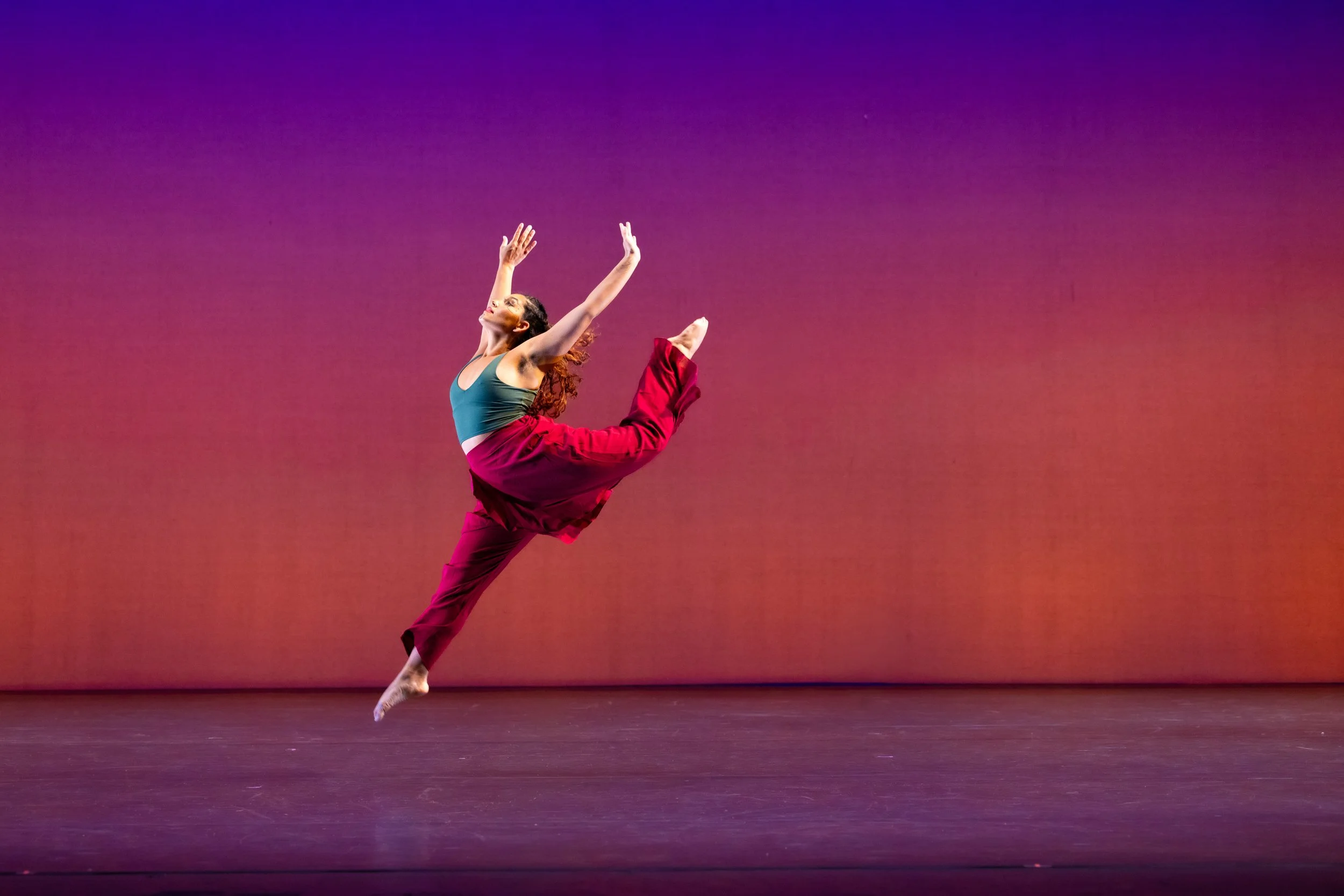 dancer jumping in red pants