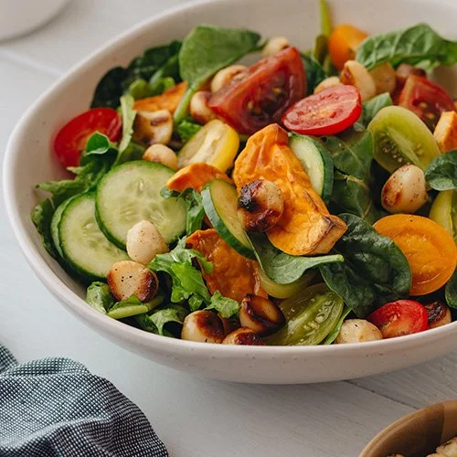 Roasted sweet potato with spinach, tomato, toasted macadamia nuts and cucumber salad.