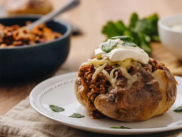 Low FODMAP Beef chili served with Baked Potato, cheese and sour cream