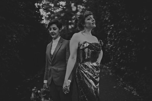 a black and white image of a same sex couple on their wedding day