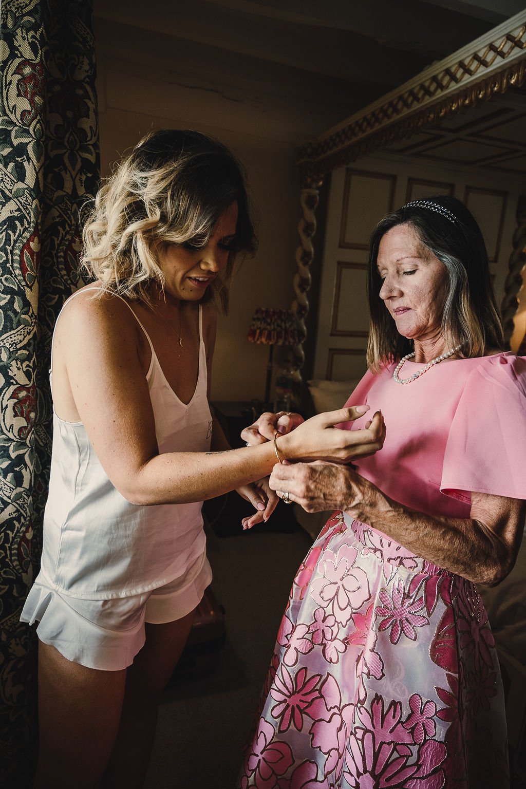 mother of the bride helping her to get ready