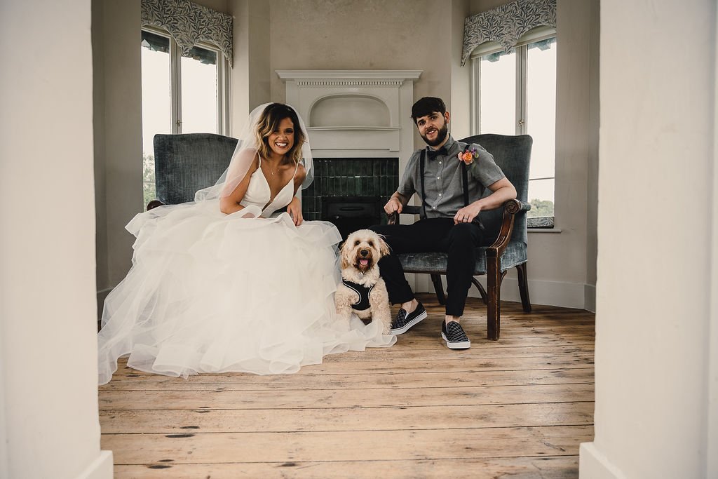 a bride and groom portrait with their pet dog