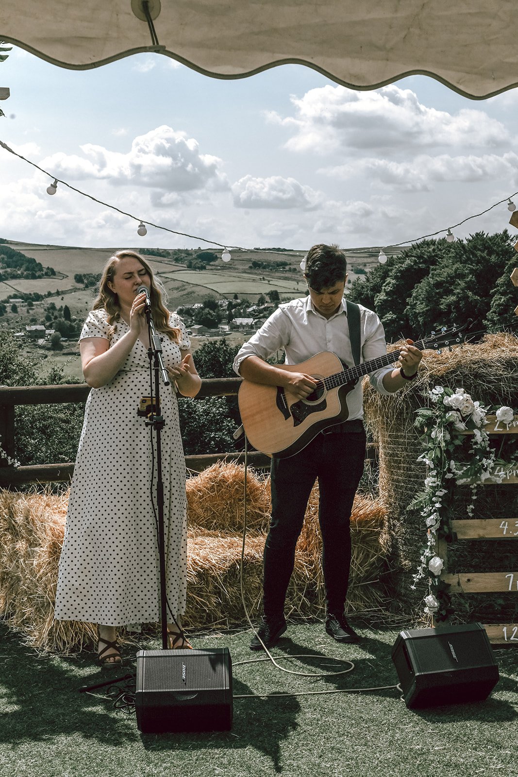 a man and woman performing at an outdoor wedding