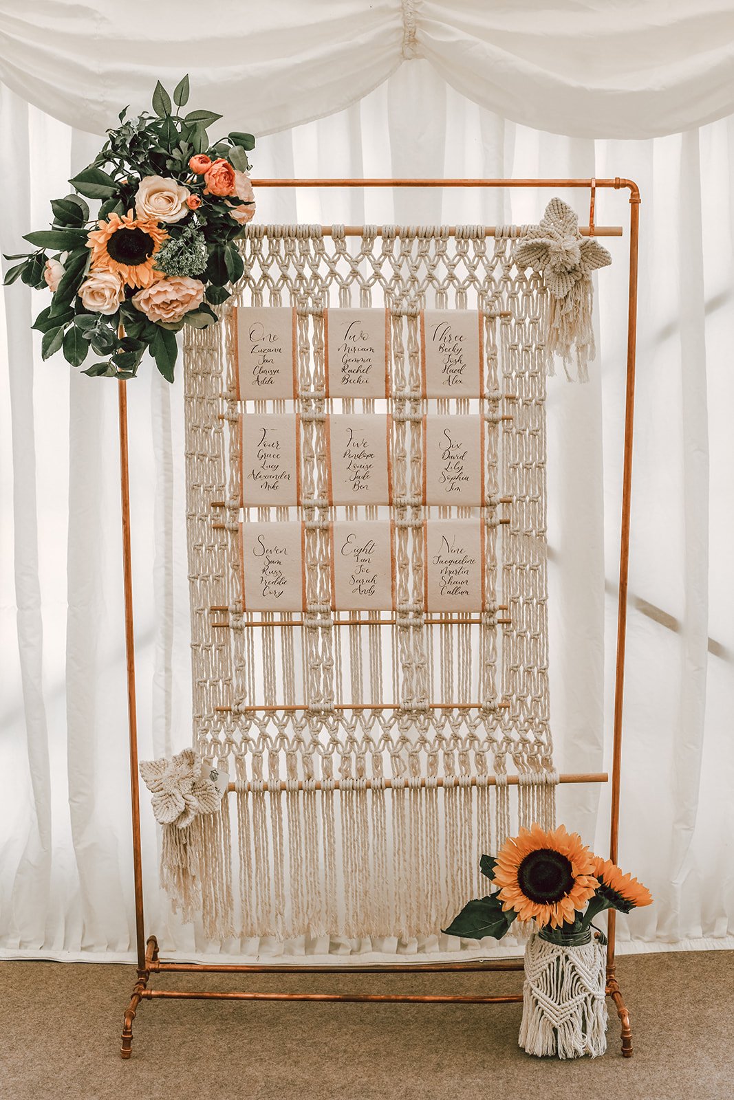 macrame seating plan on a copper stand