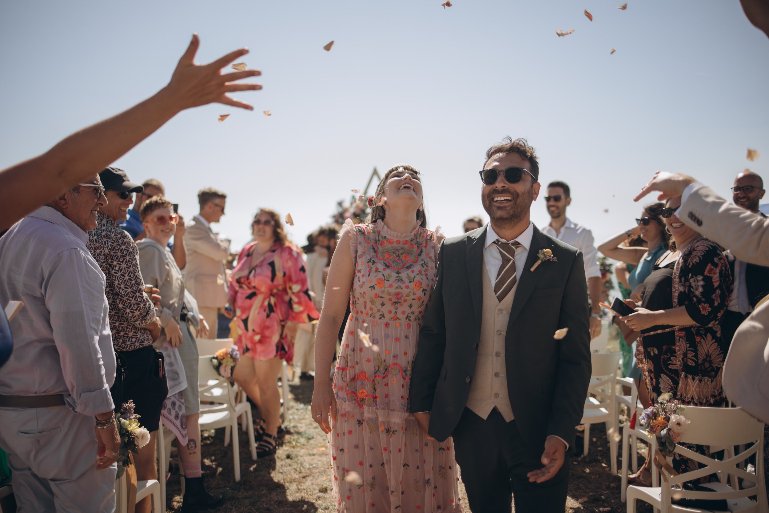  Bride and groom can be seen laughing as they walk back up the aisle on the beach after their funny ceremony led by the inclusive celebrant.  Photo by: Lisa Elisa Photography 