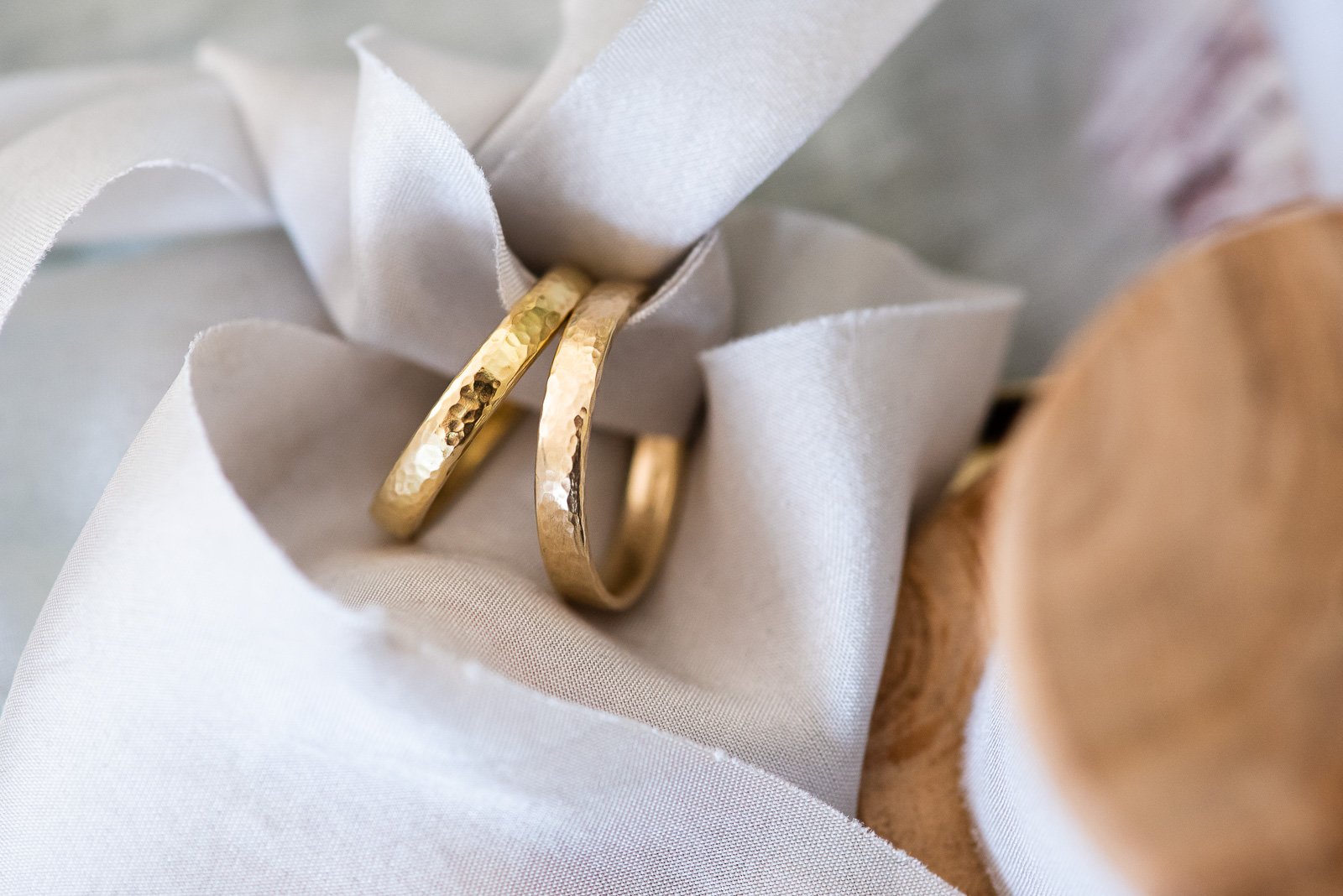  Two matching narrow, hammered gold wedding bands  Photo by: Fiona Kelly 