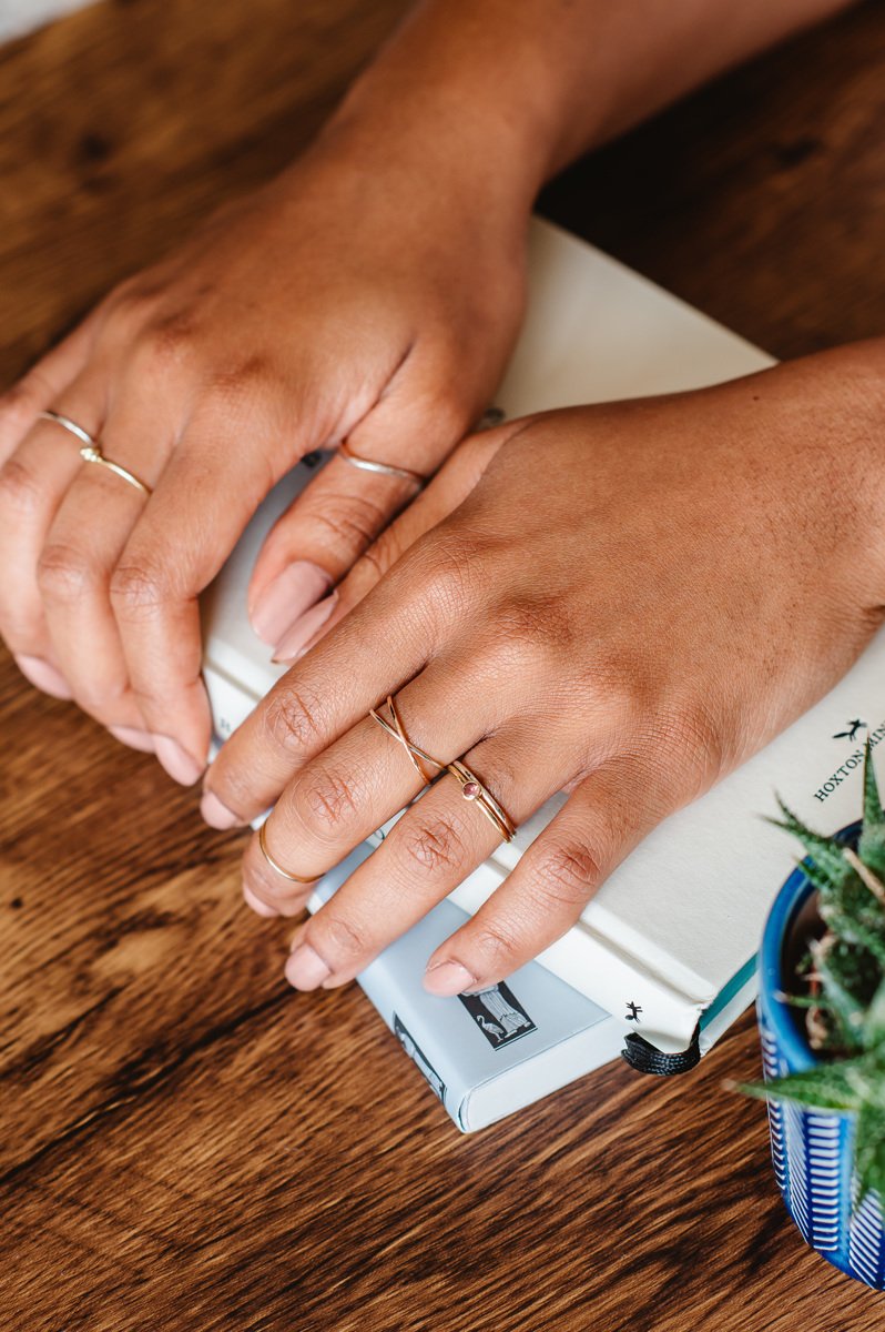  A selection of the handmade, thin, slim wedding bands worn separately and together alongside wedding rings set with ethically sourced stones.  Photo by: Fiona Kelly 