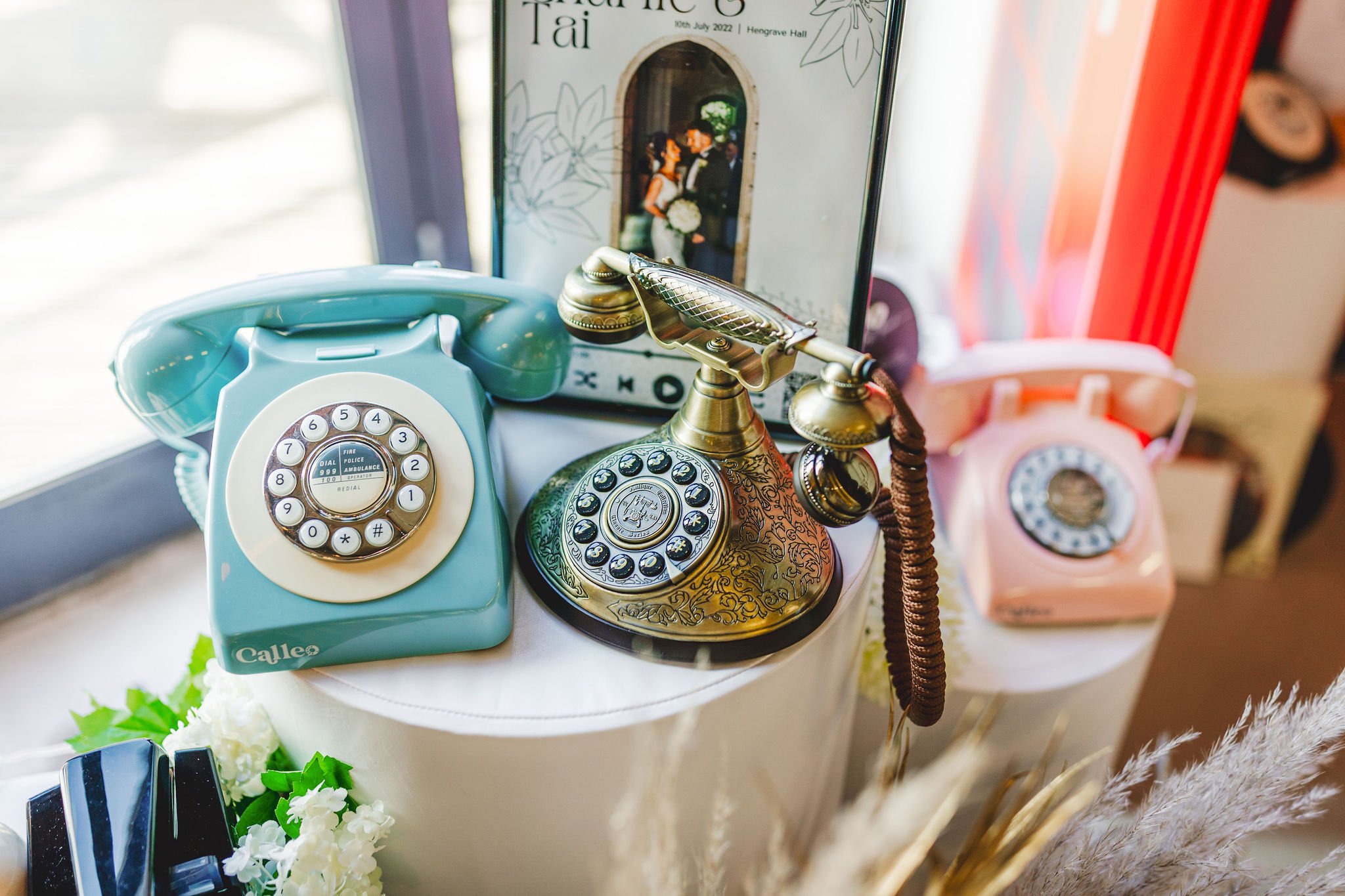  Three retro phones are displayed next to each other to choose from to hire for your wedding so wedding guests can leave audio messages. 