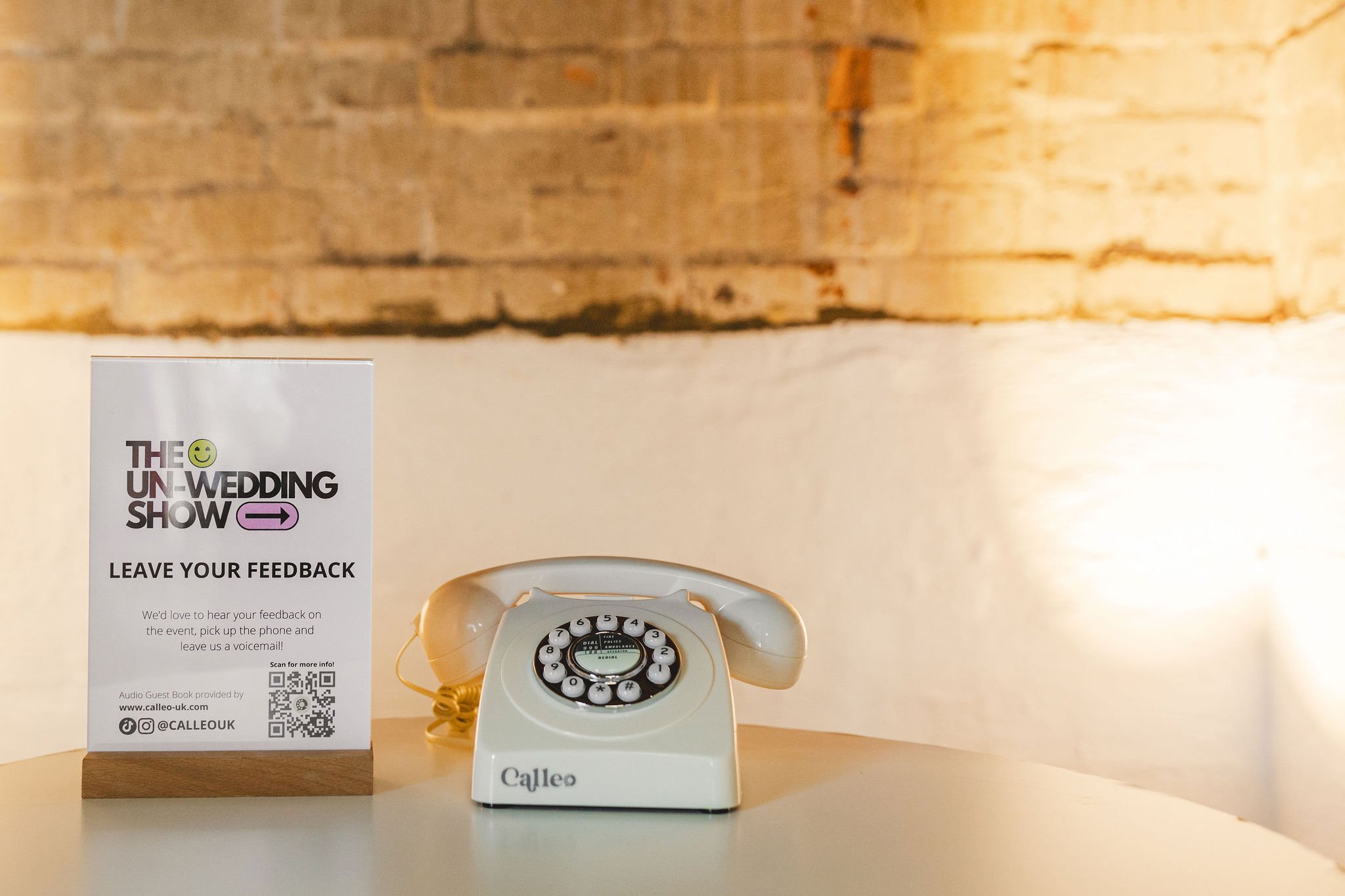  The cream retro Calleo phone is displayed on a table in an exposed brick recess within Paintworks, Bristol where attendees and suppliers can leave feedback about The Un-Wedding Show. 