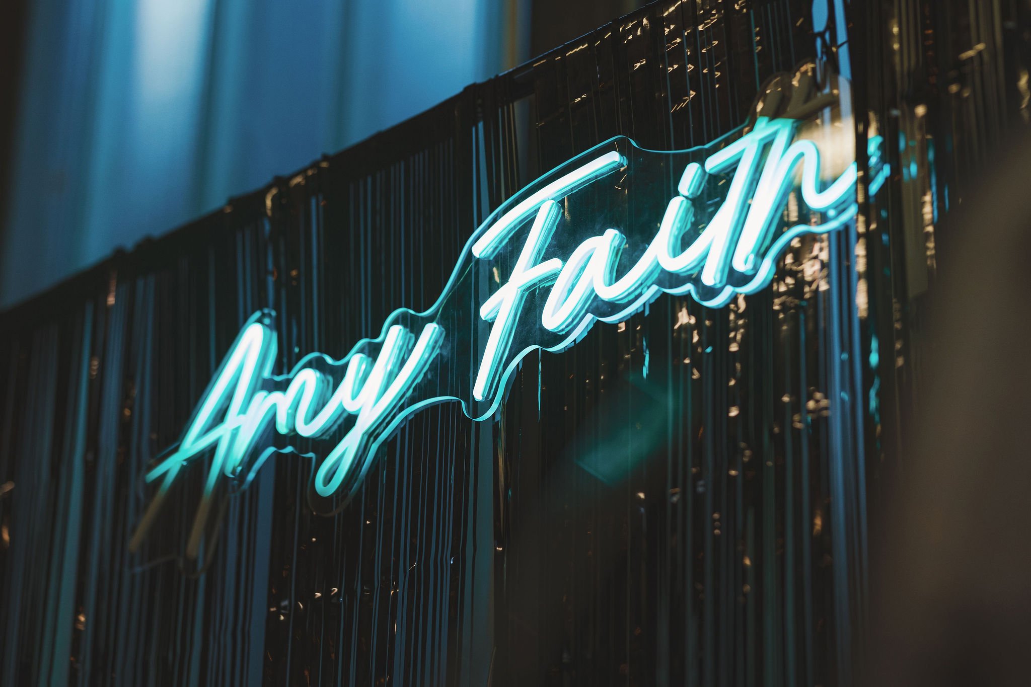  Blue neon sign of alternative wedding photographer’s name AMY FAITH 