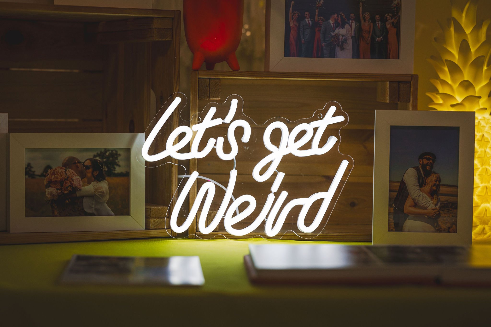  Neon LETS GET WEIRD light on stand in front of images at The Un-Wedding Show Bristol 
