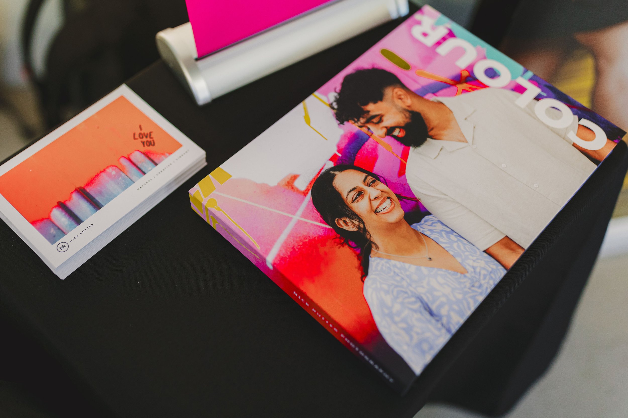  Bright image of a couple by wedding photographer is printed on canvas with the word COLOUR printed up the side. 