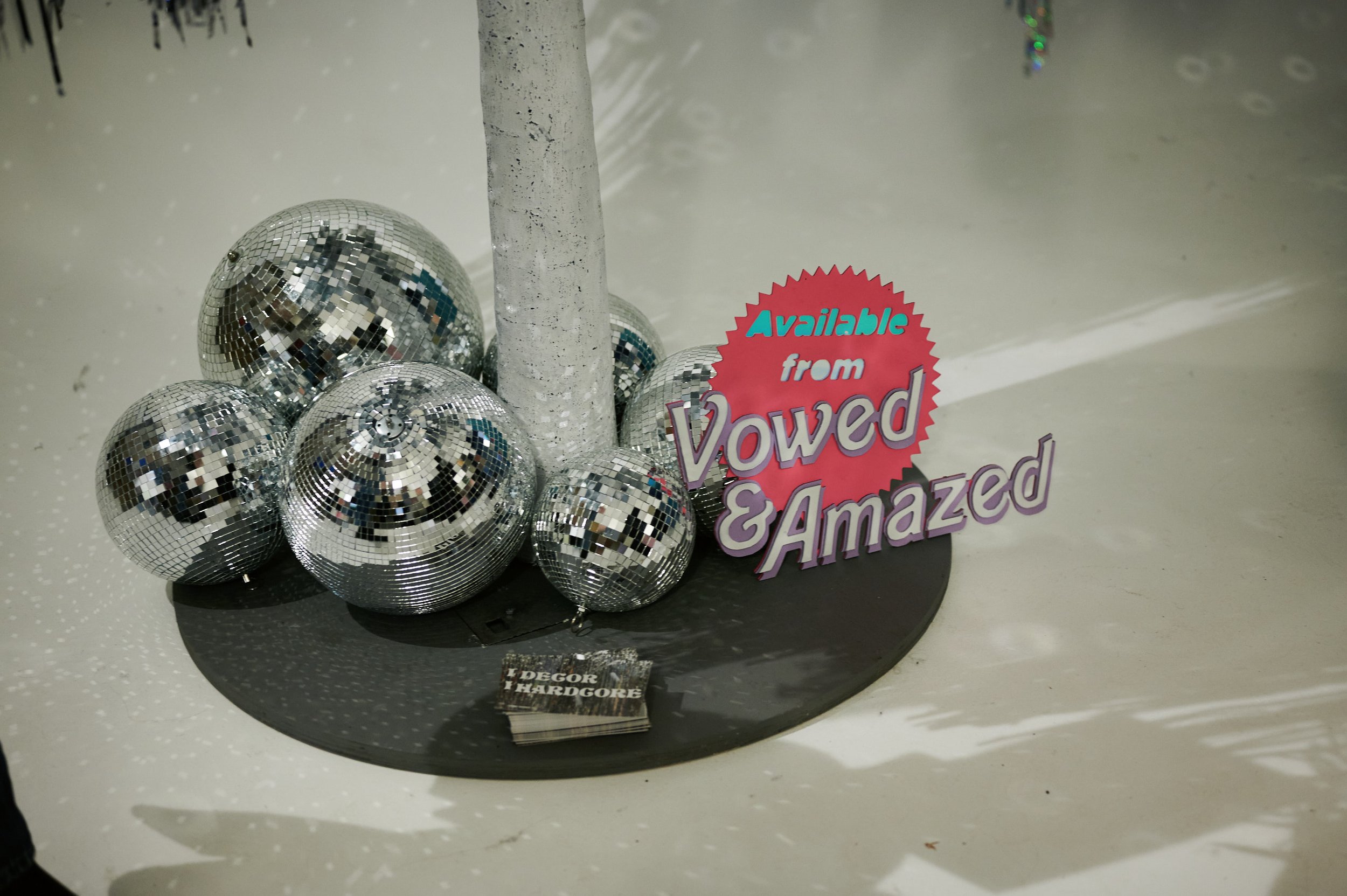  A group of silver disco balls and a sign that says ‘Vowed &amp; Amazed’. 