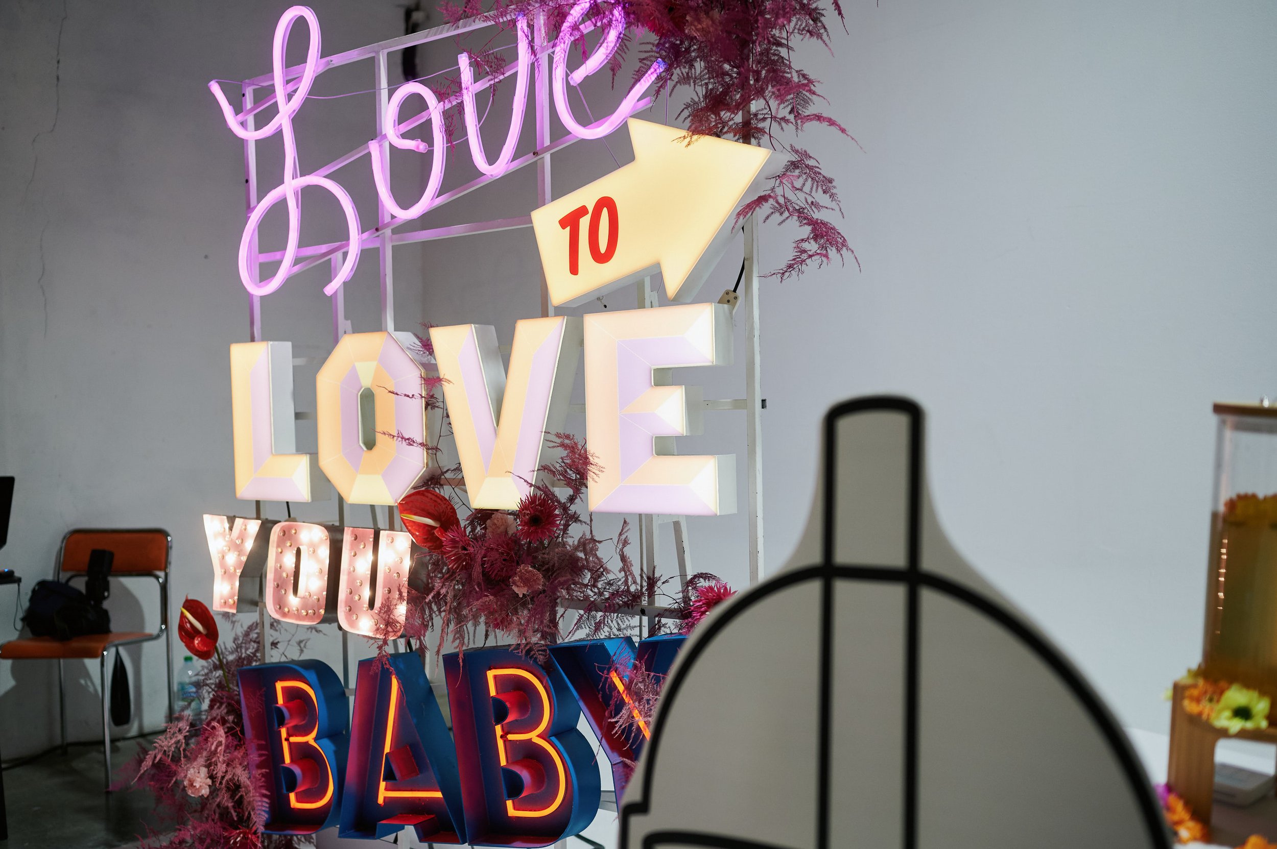  A neon sign at The Un-Wedding Show that says ‘Love To Love You Baby’ in different fonts and colours. 