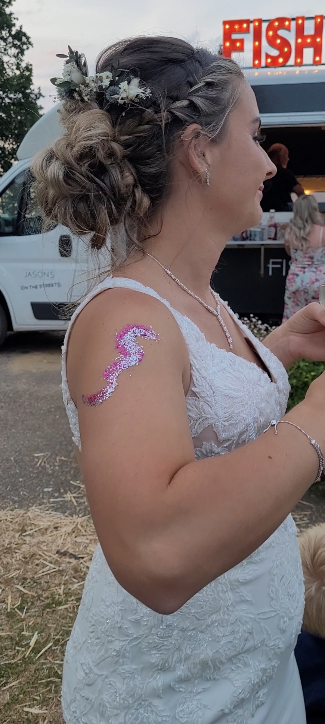  Bride’s arm with a silver and pink glitter seahorse. 