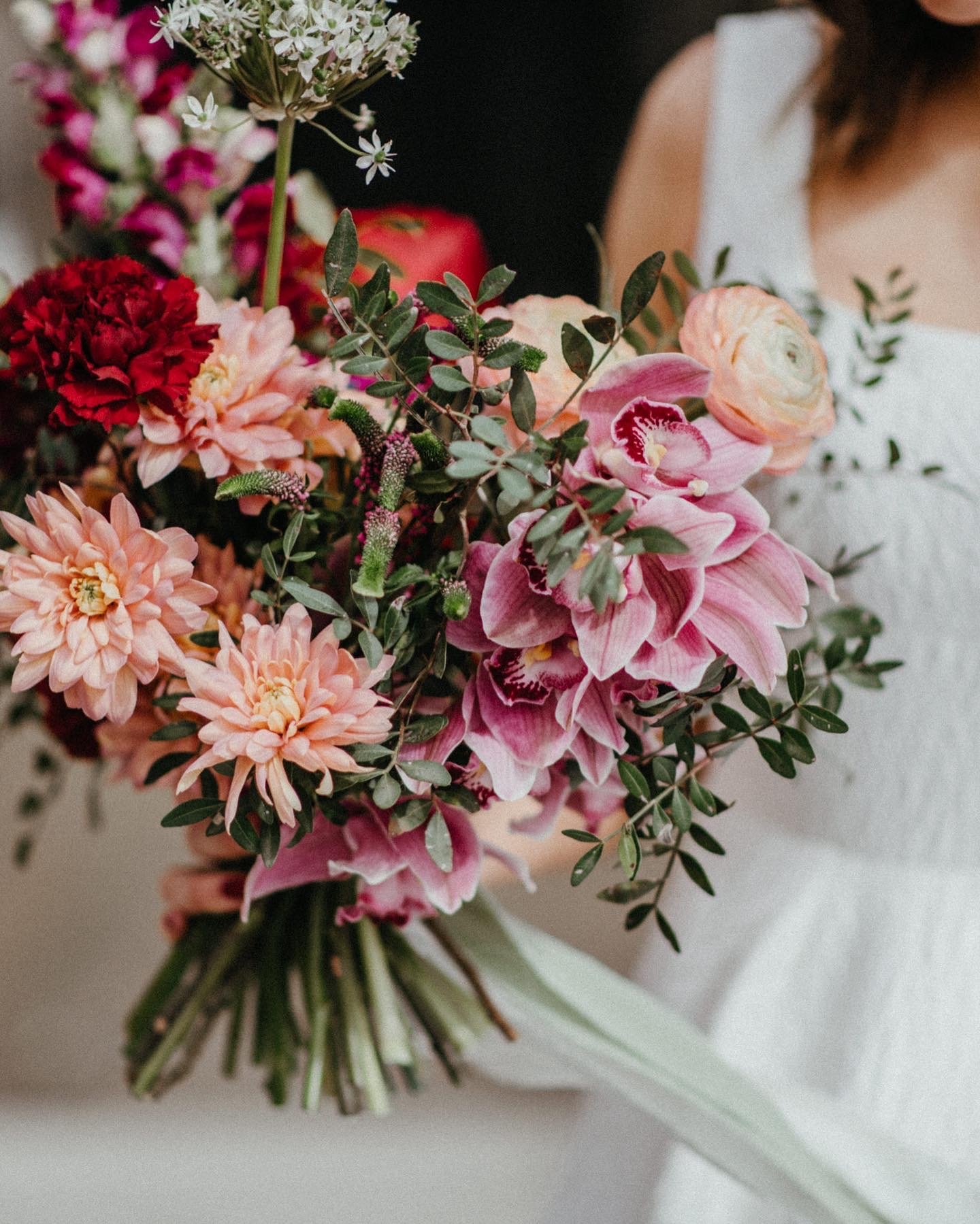  A close up image of a modern, hand-tied pink floral bridal bouquet.  Photo by Lisa Devine Photography 