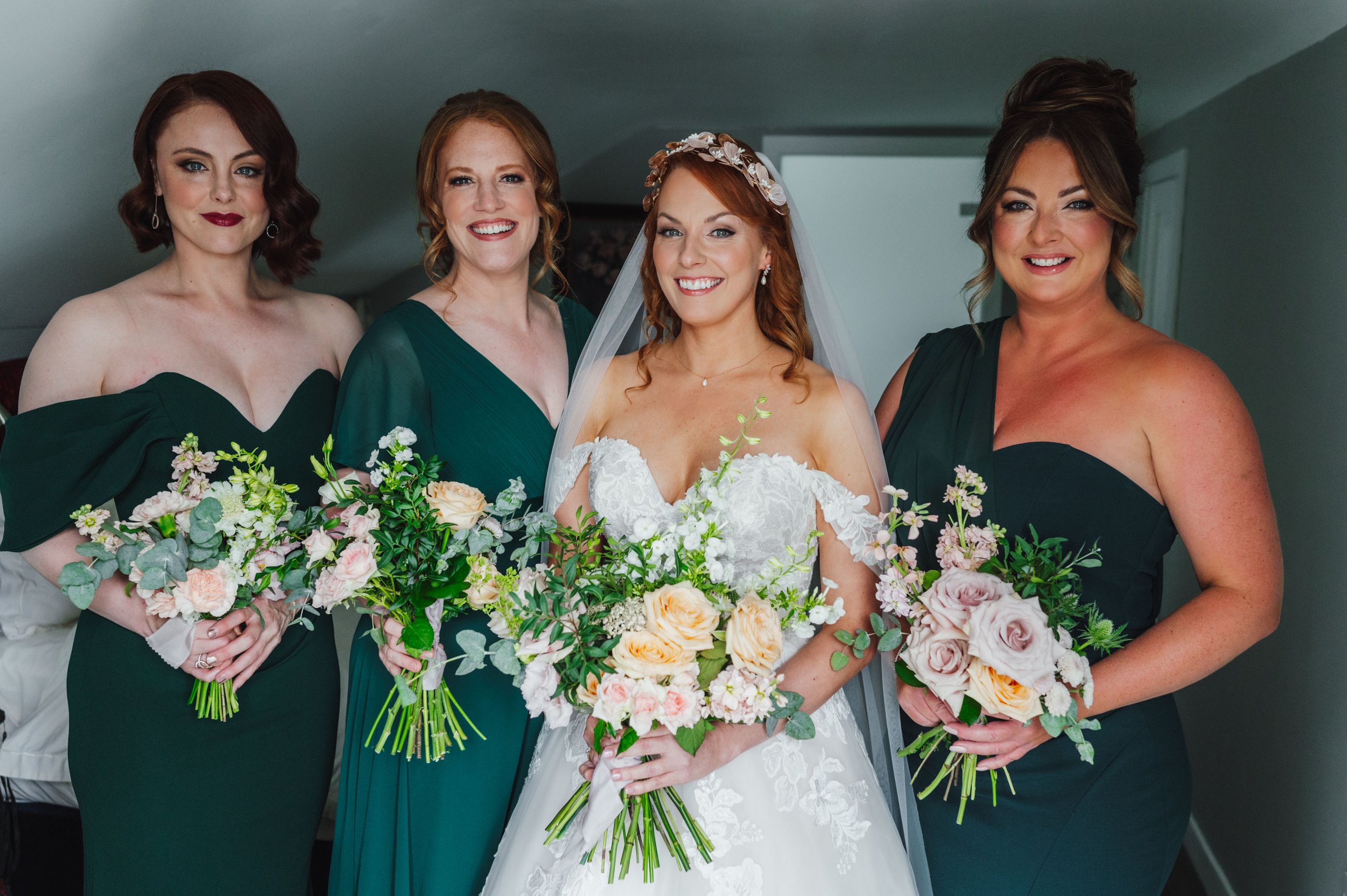  Subtle and stylish bridal party bouquets using cream florals and green foliage.   Photo by Sidey Clark Photography 