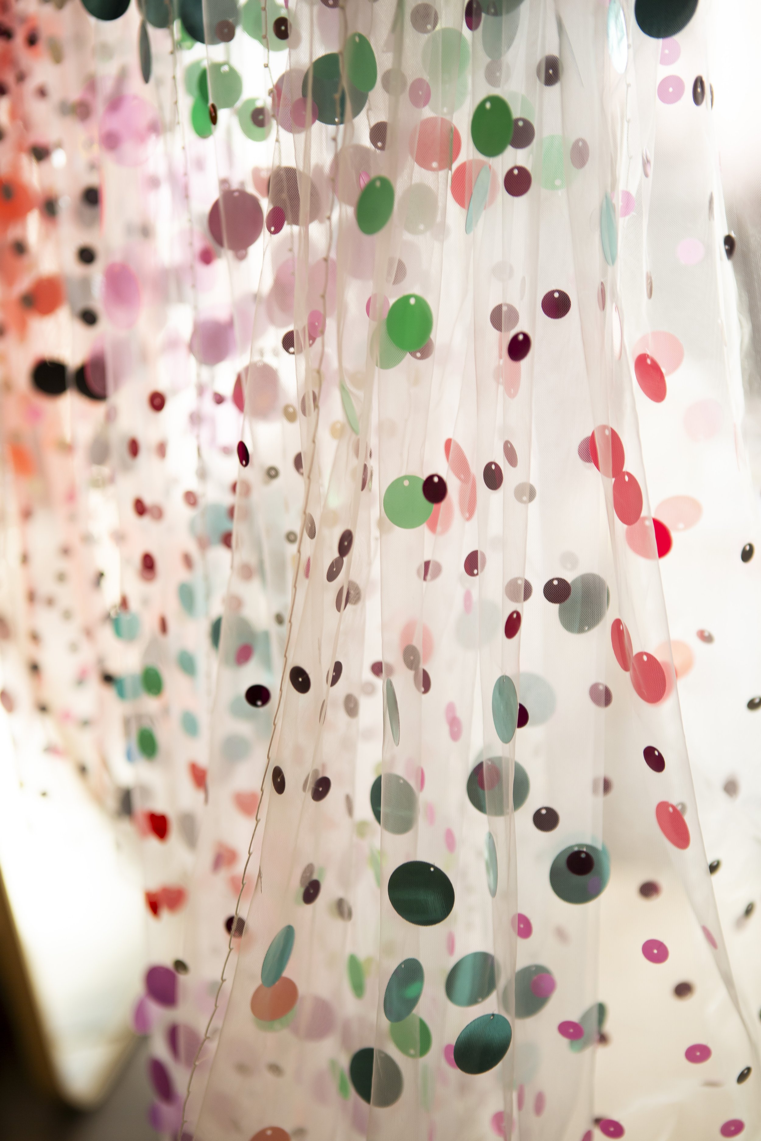  Close up image of beautiful wedding fabric adorned with bright sequins. 