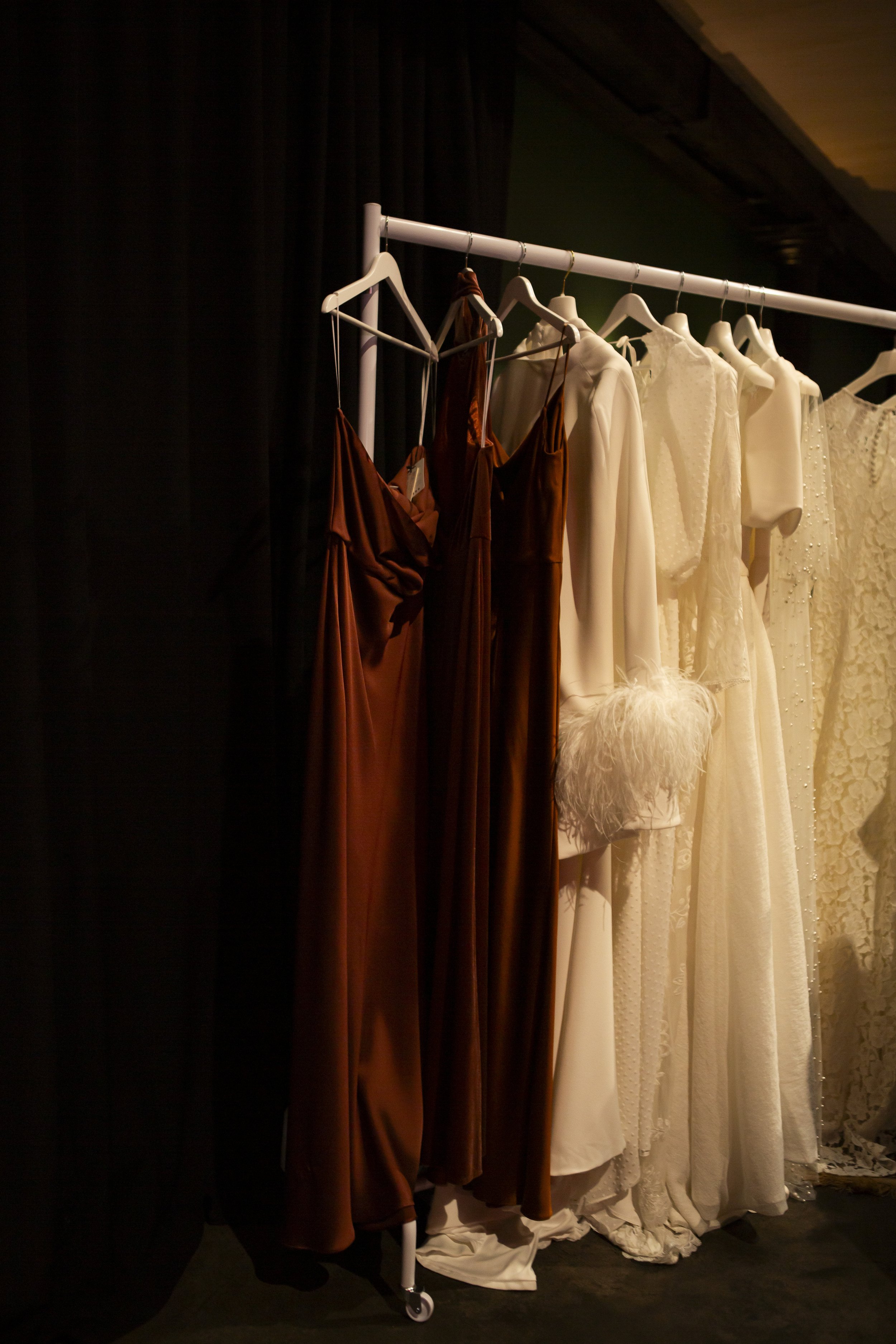  Individual, non traditional wedding and bridesmaid dresses. The brown and cream dresses in various different styles and fabrics look stunning on the rail.  