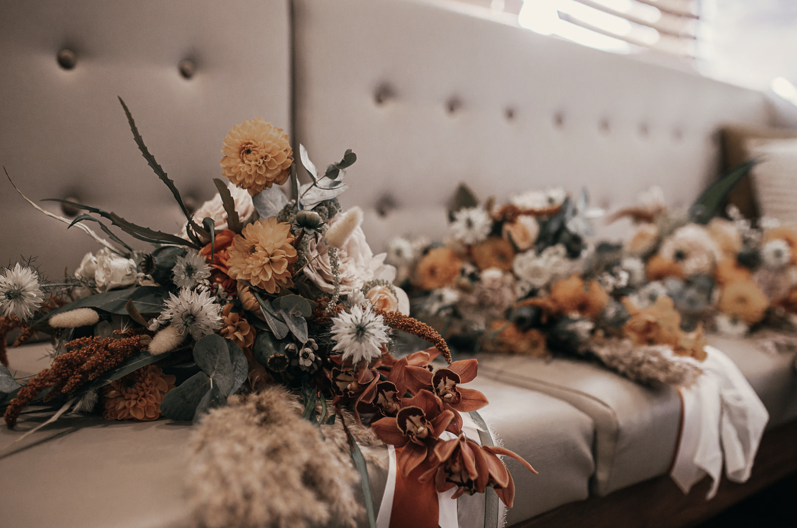  Stunning wedding arrangement created using dried and real flowers in autumnal colours.  Photo by Iris I Photography 