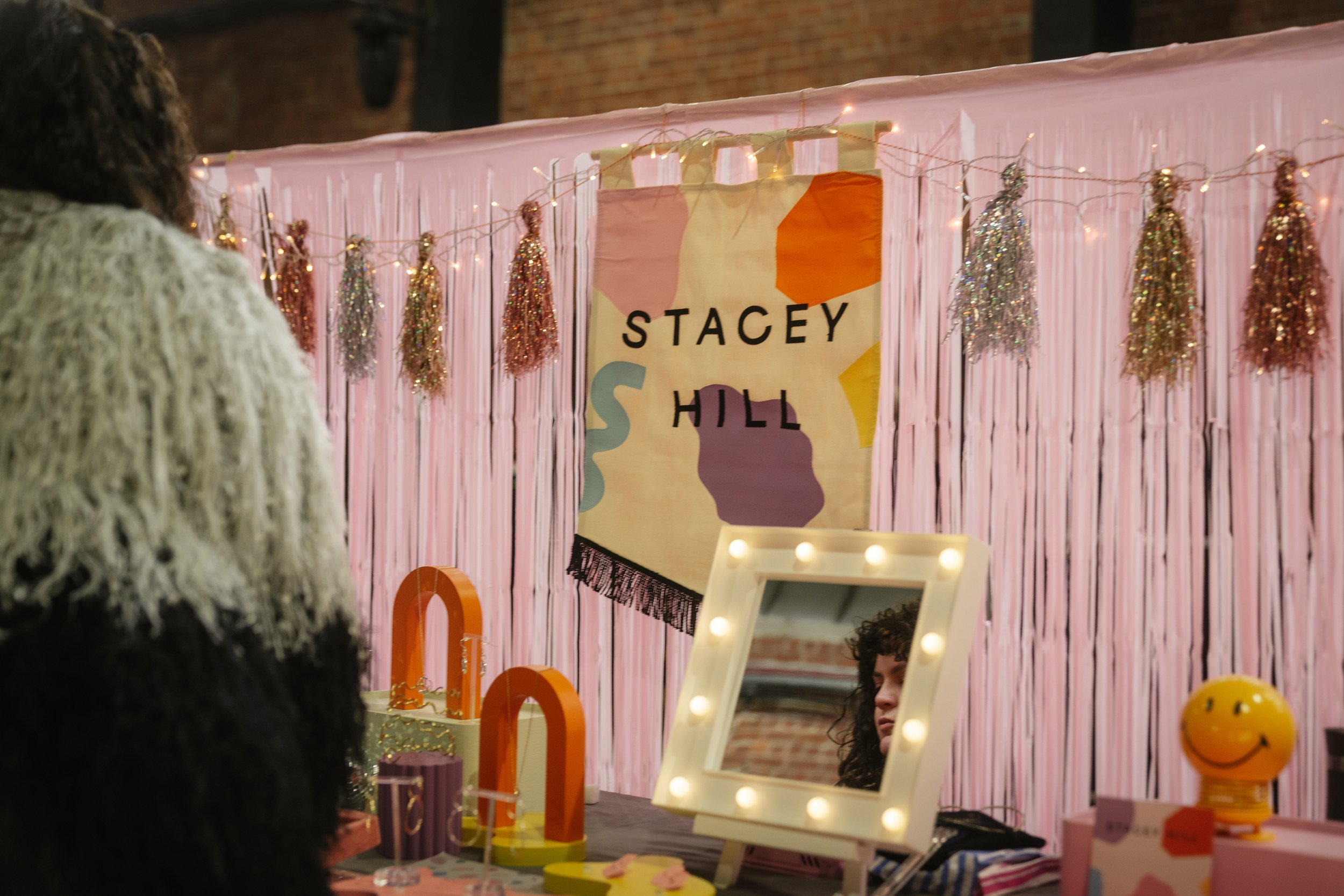  STACEY HILL banner against streamers which are hung behind awesome wedding jewellery showcased at various heights. 