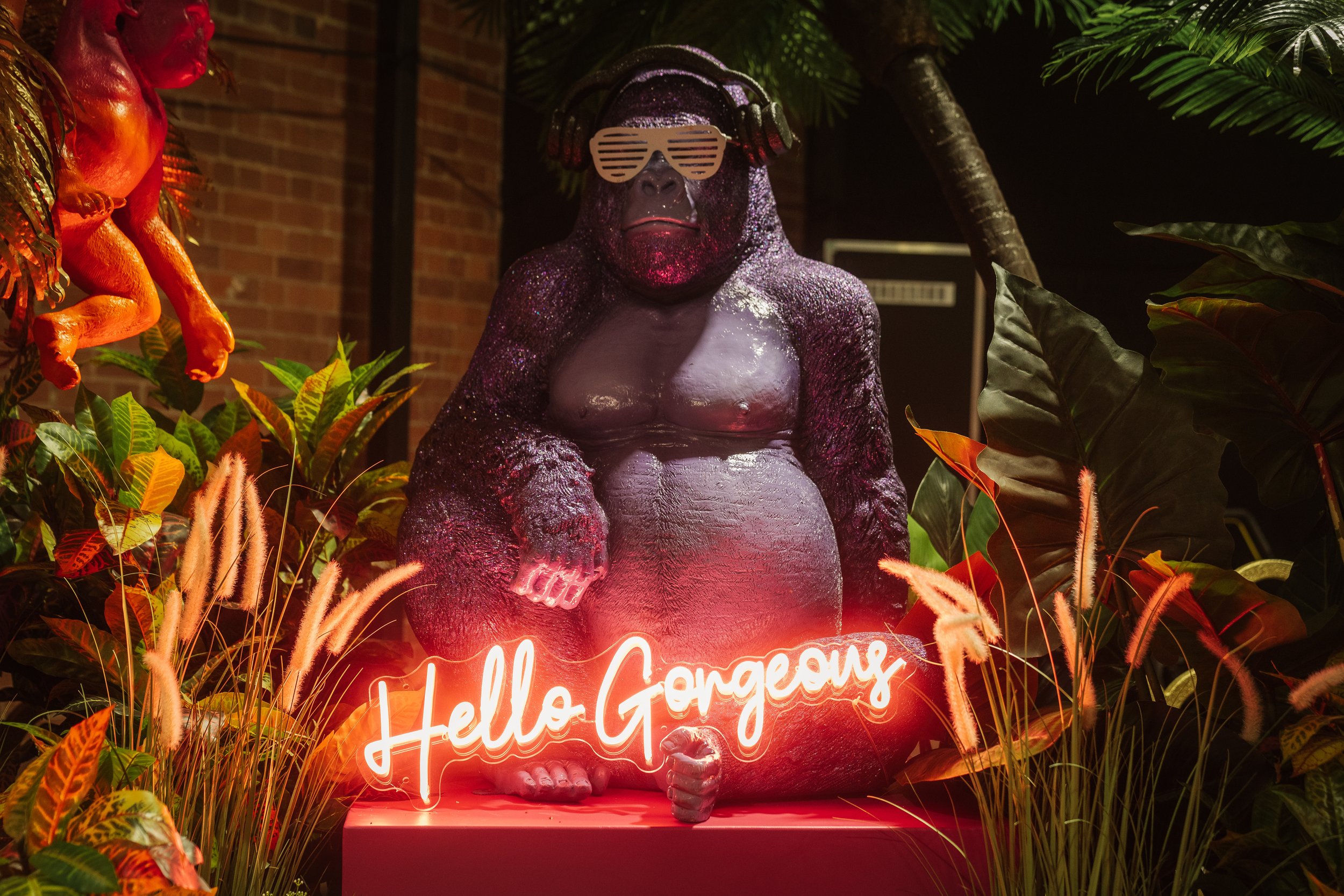  HELLO GORGEOUS neon in front of a giant gorilla that can be hired for weddings. 