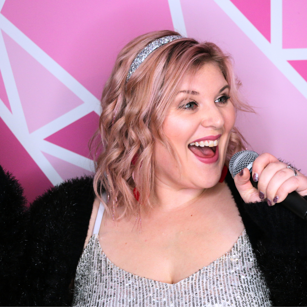 An up-close image of the wedding singer singing into a microphone.