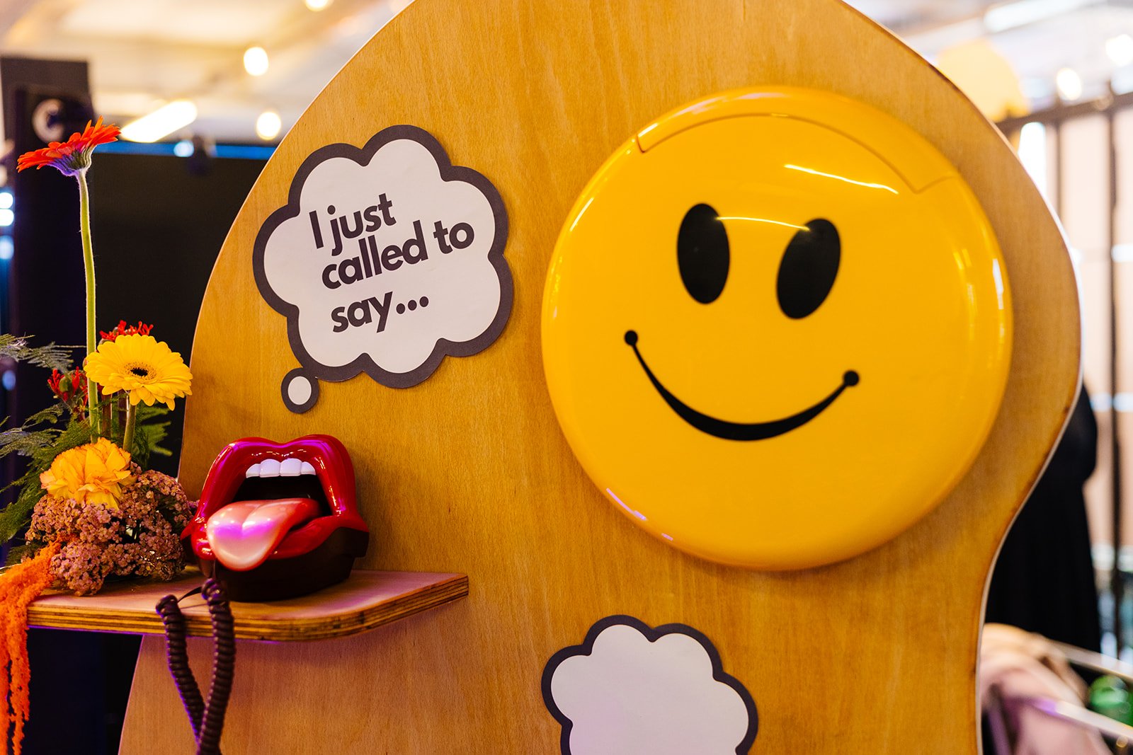  A yellow smiley face audio guest book with a speech bubble shaped sign that says, I just called to say… 
