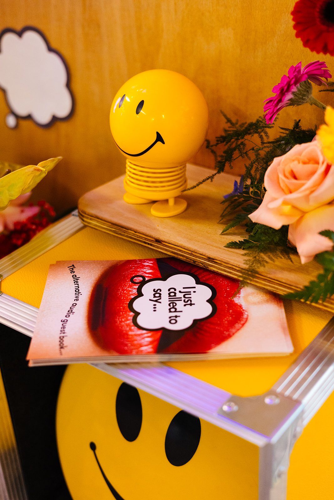  A close up of some cute details at The Un-Wedding Show Sheffield. There are some flowers, a smiley face toy and some flyers with big red lips that say ‘I just called to say… 