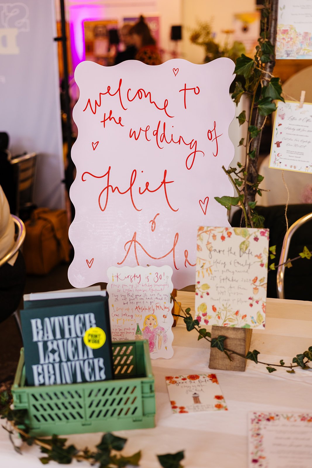  A cute, red and pink table sign at The Un-Wedding Show. 