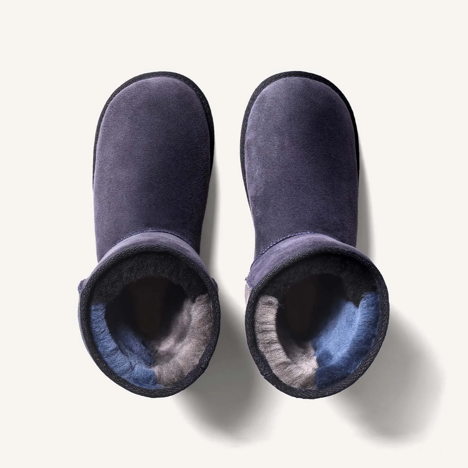 Pair of blue grey sheepskin boots seen from above.