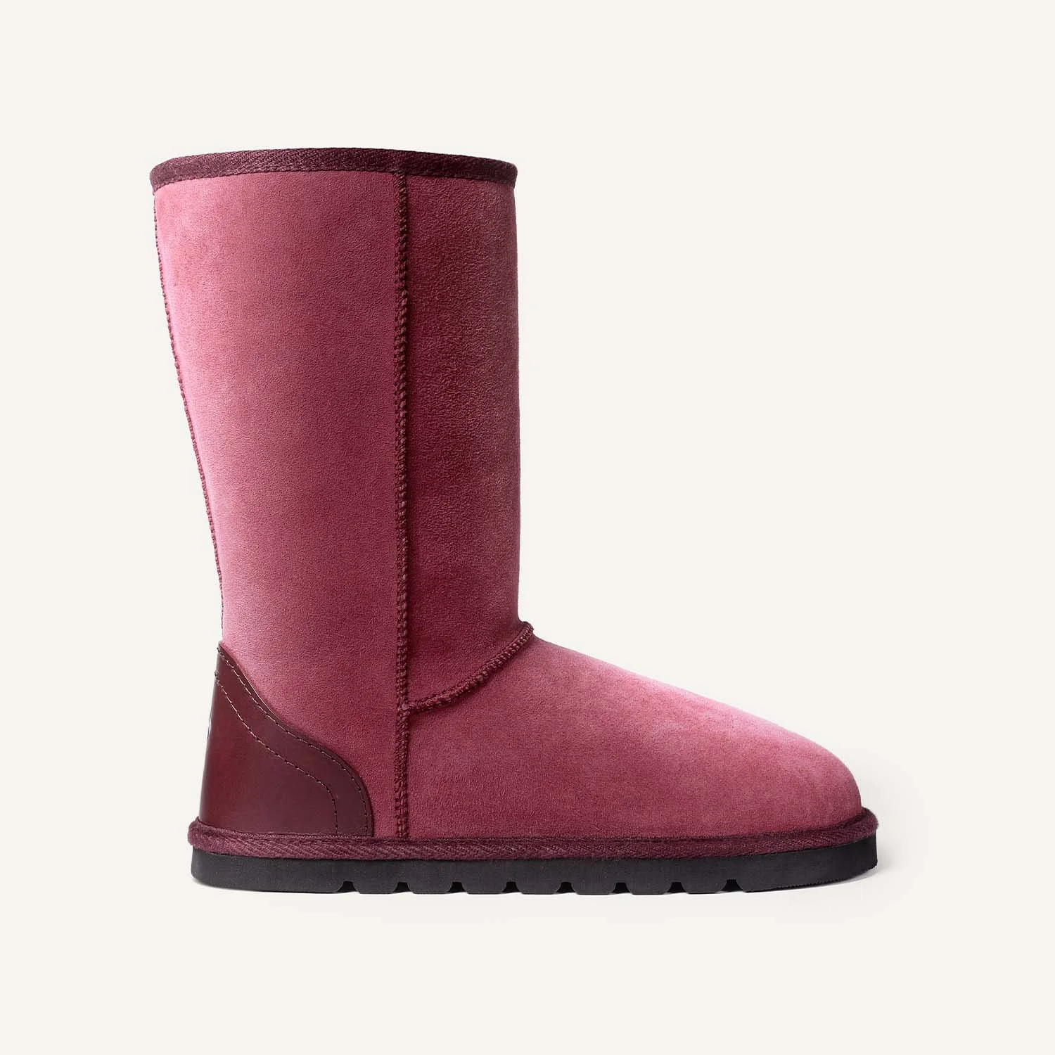 Tall pink sheepskin boot seen from the side.