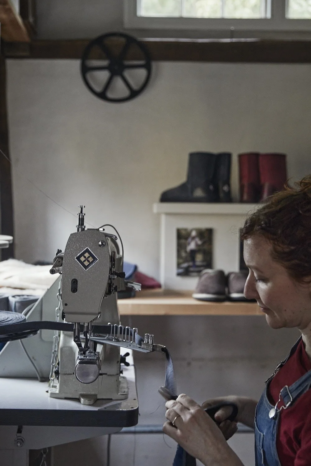 Xanthe sewing in her workshop.