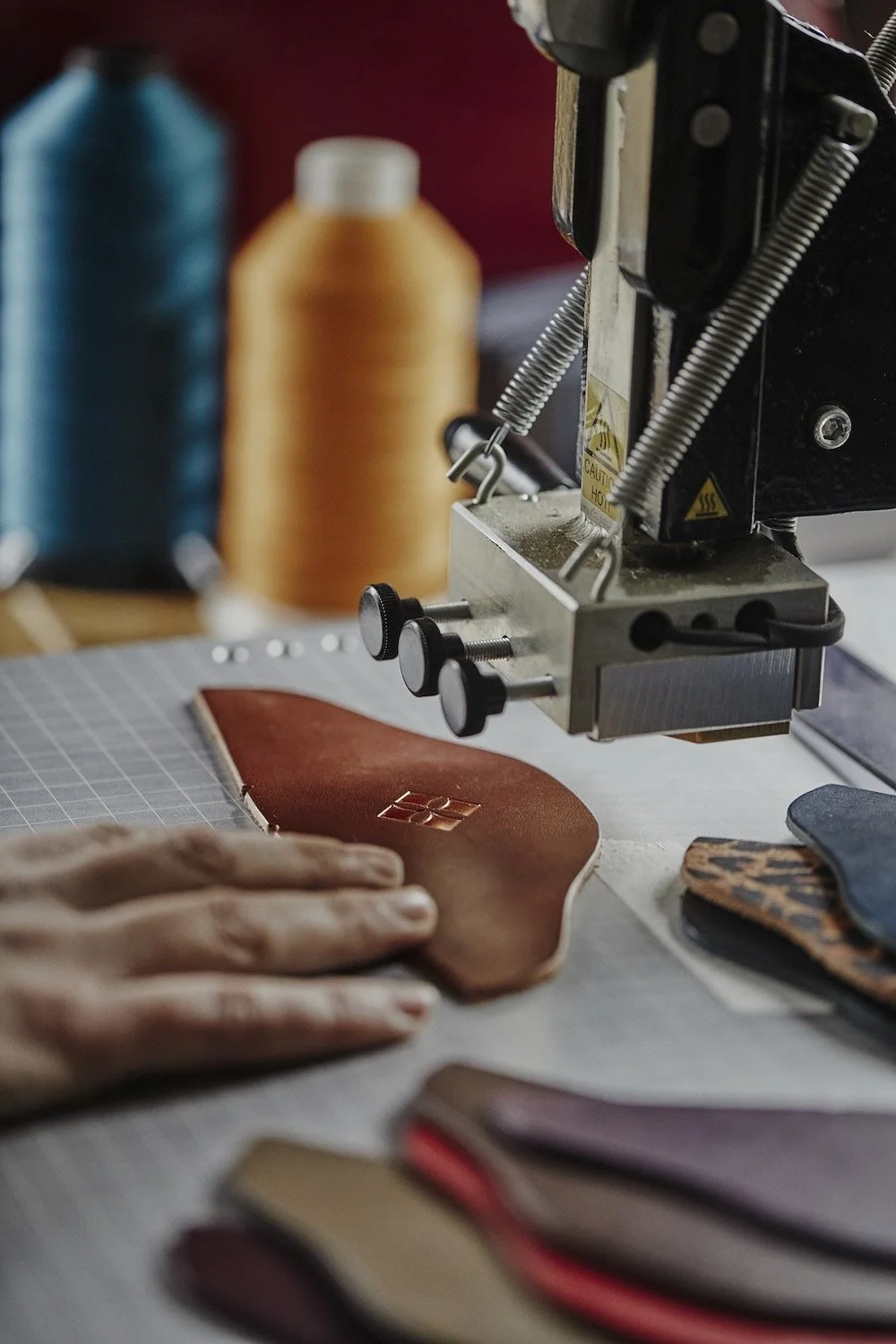 Leather heel in tan colour being embossed, or de-bossed in copper