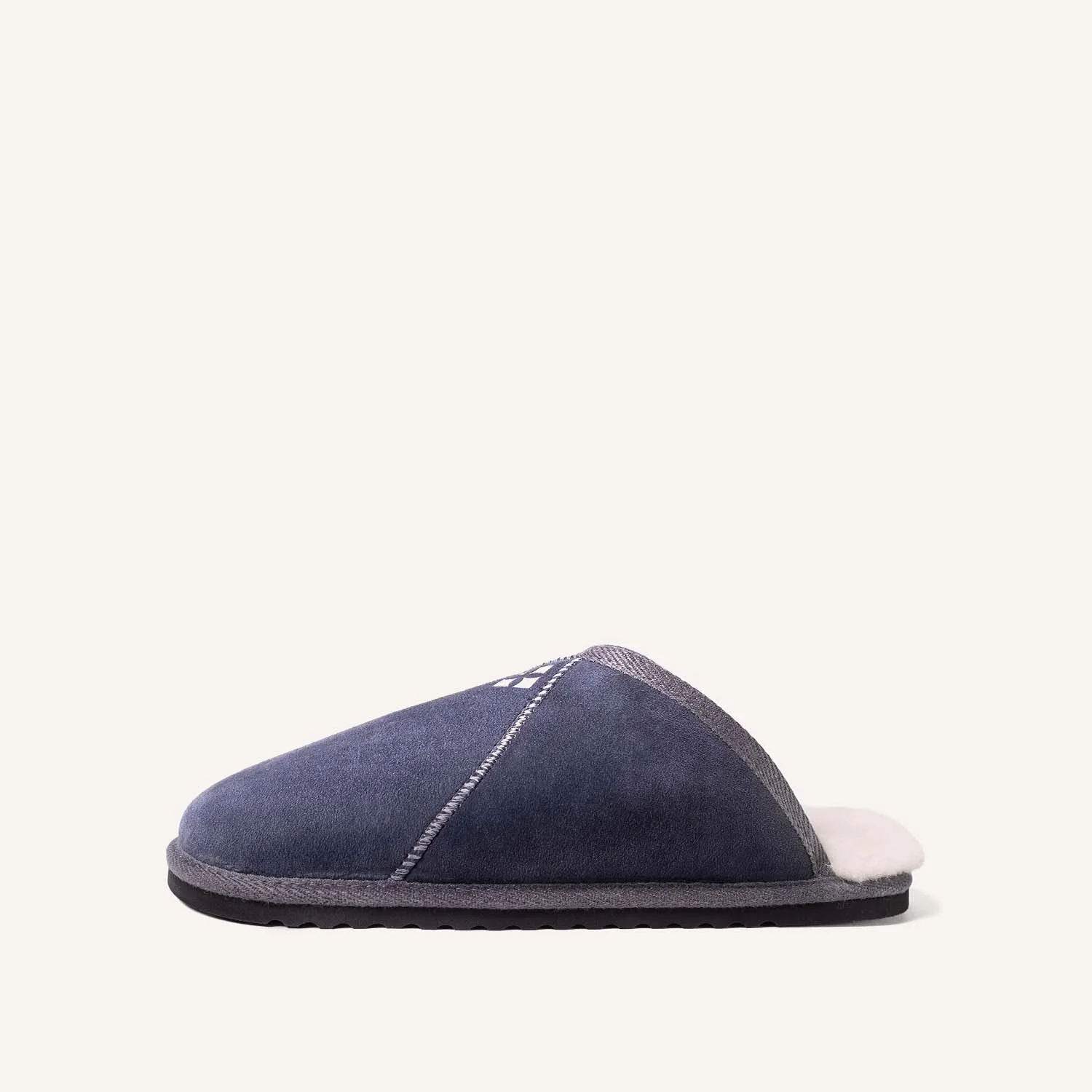 A blue sheepskin slipper shown in profile.