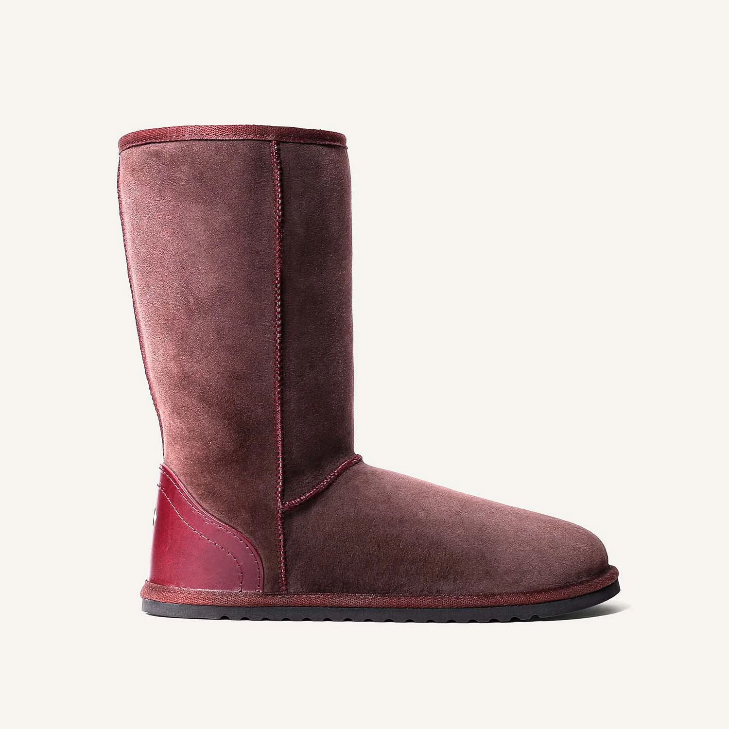 Tall brown sheepskin slipper boot with hard sole.