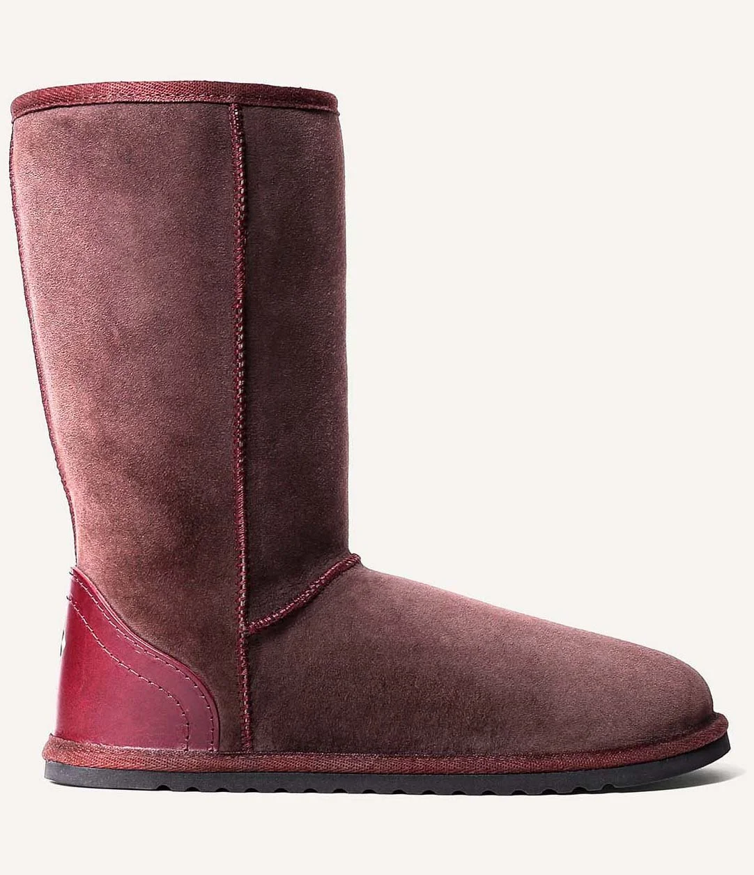 Tall, brown sheepskin slipper boots, seen in profile.