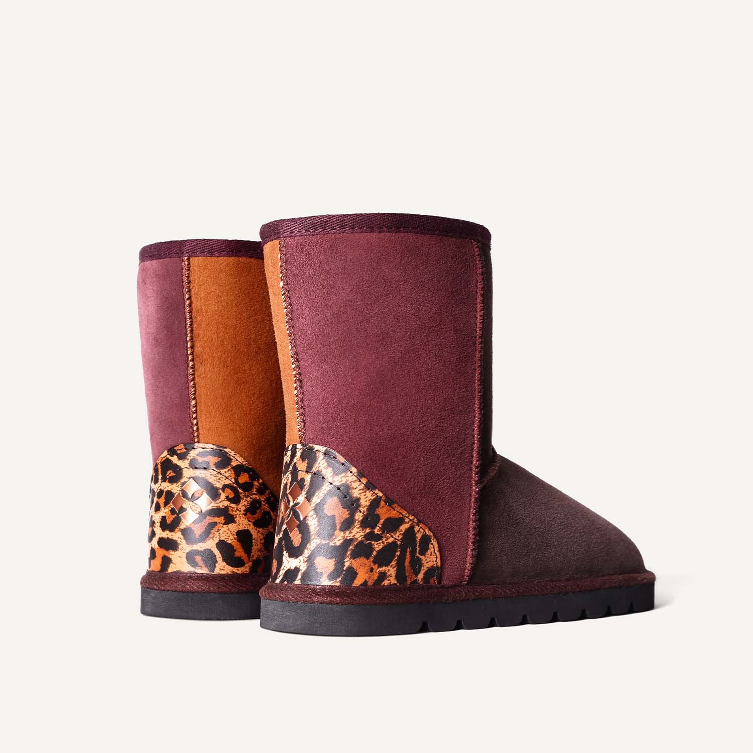 Pair of sheepskin boots with leopard print leather.