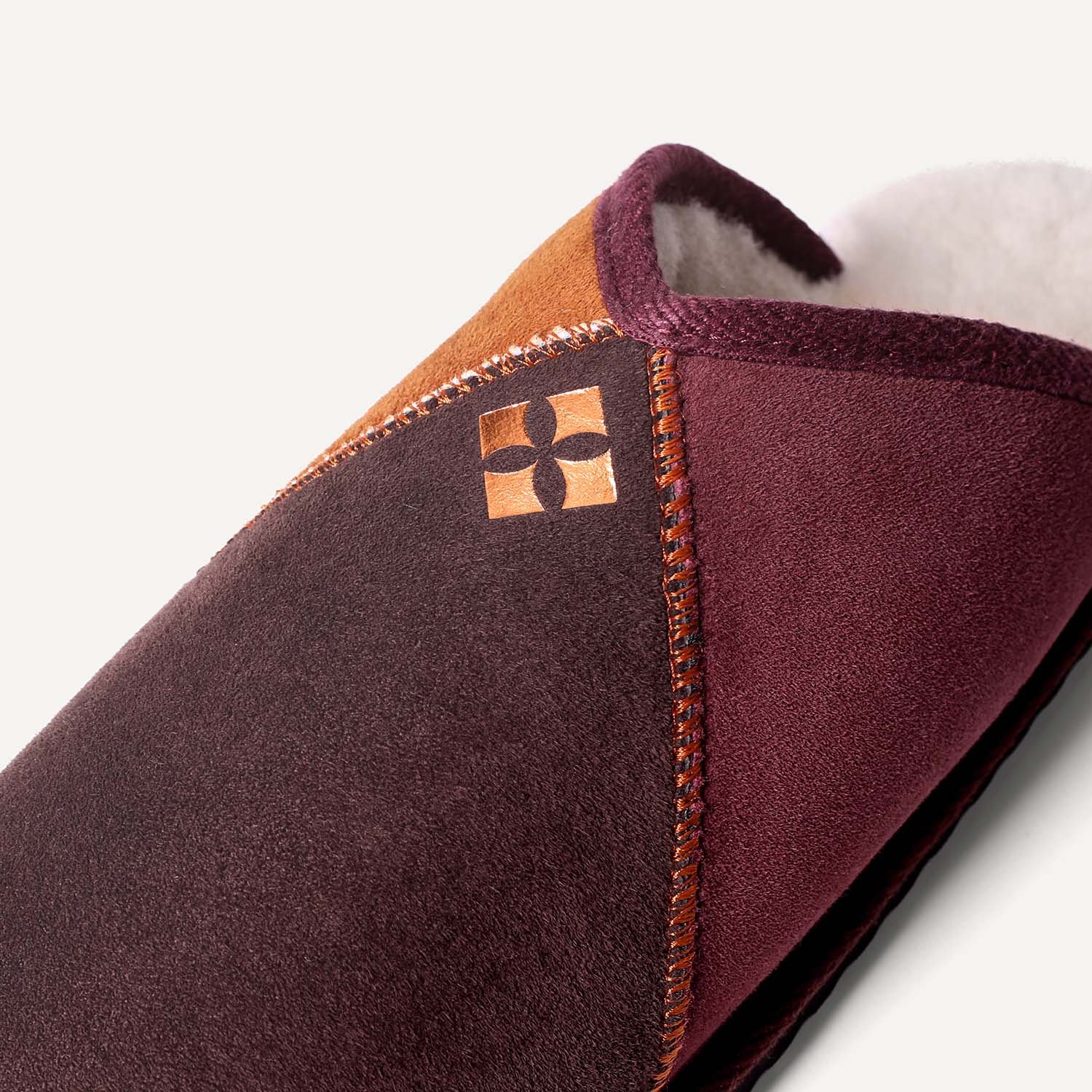 Close up of copper logo on slippers.