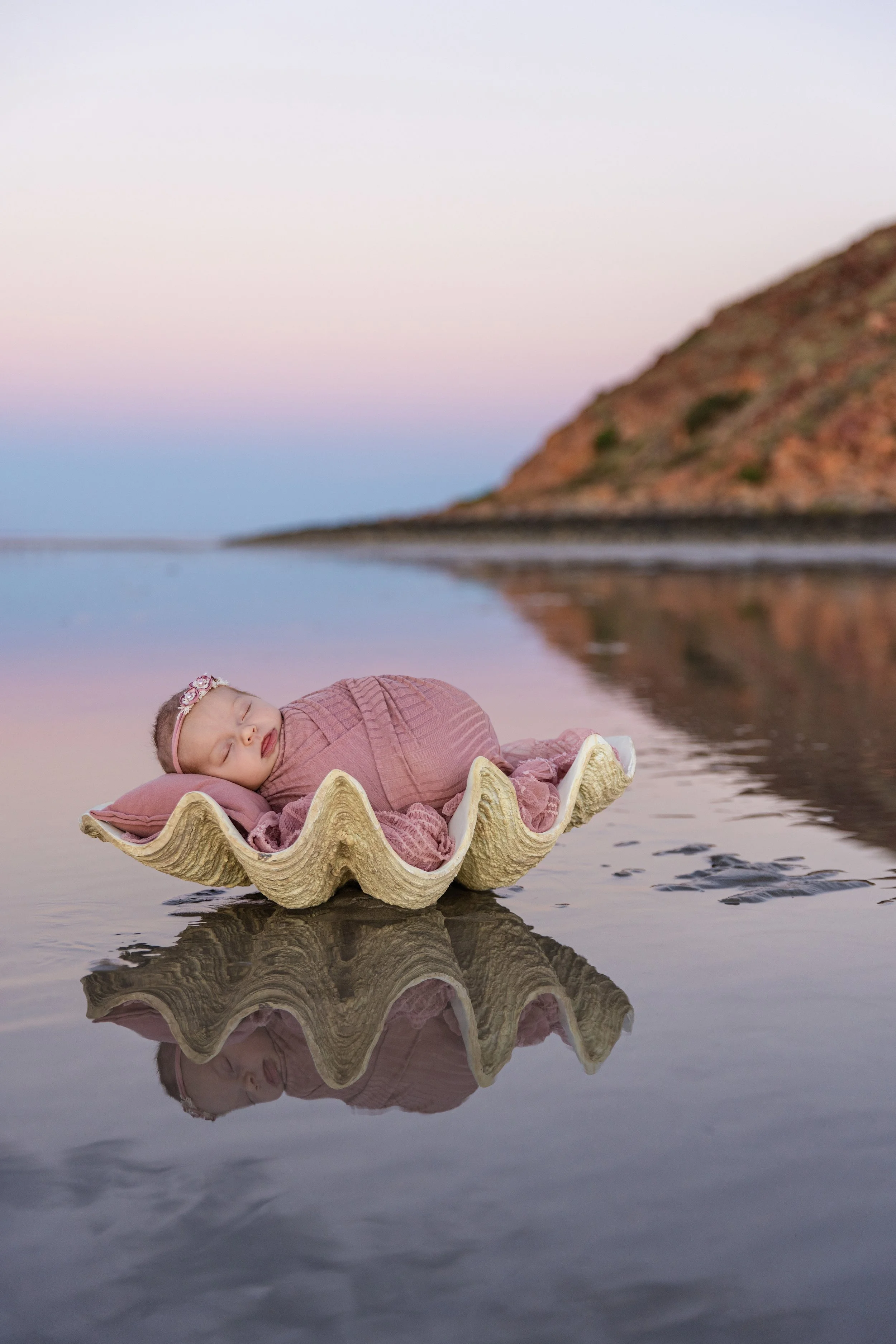 outdoor sunset newborn girl photoshoot on the beach