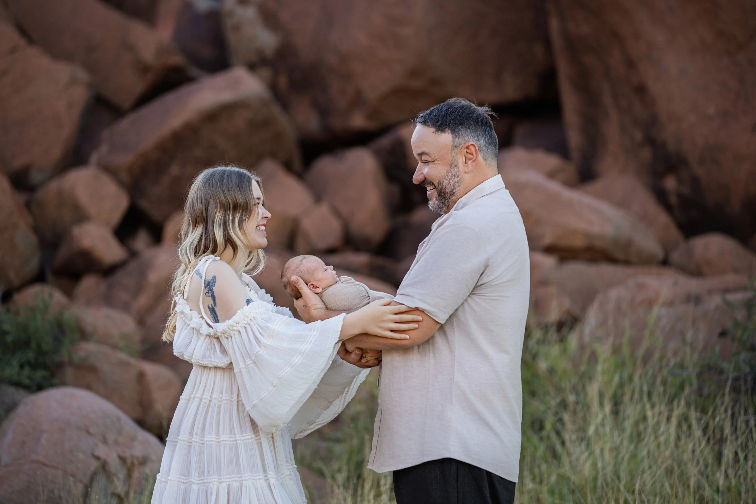 Outdoor newborn photoshoot in karratha with mum and dad holding there little baby