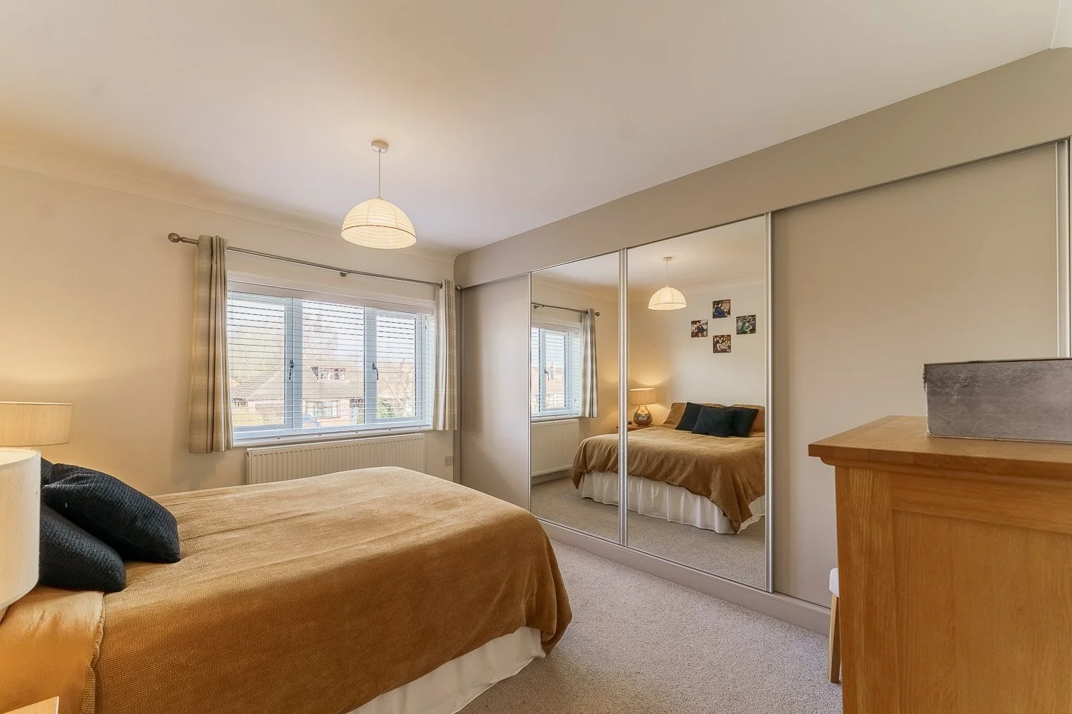 Bedroom photograph through mirror emphasing space by real estate photographer in York and Selby
