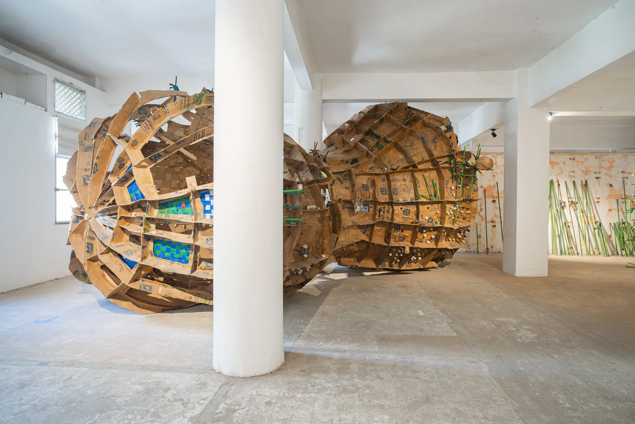 NITTÉ MOY GARABAM, 2025, Installation of cardboard, recycled plastic, wooden board with various objects (8 modules), 950x450x350CM